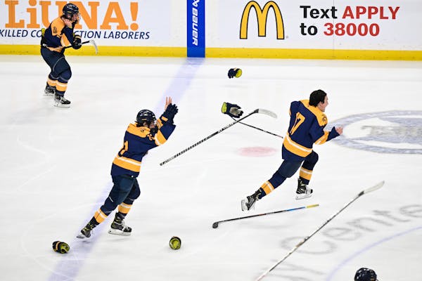 Sticks, gloves and helmets fly after a Mahtomedi double overtime win against Warroad Saturday, March 11, 2023 at the Xcel Energy Center in St. Paul, M
