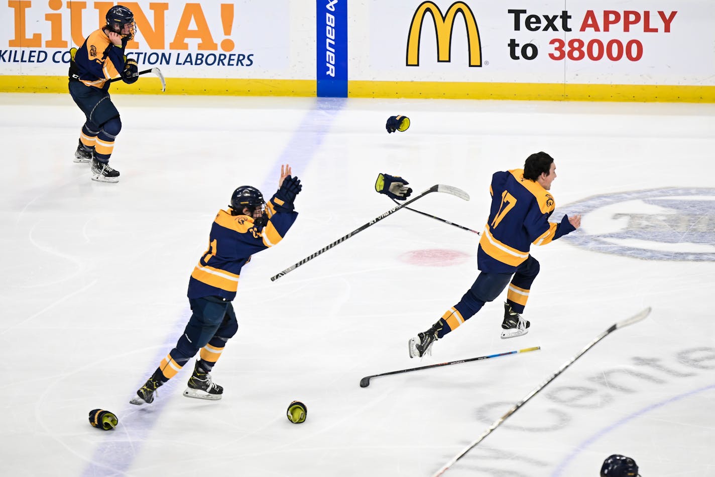 Sticks, gloves and helmets fly after a Mahtomedi double overtime win against Warroad Saturday, March 11, 2023 at the Xcel Energy Center in St. Paul, Minn. Warroad and Mahtomedi faced off in the Class 1A boys hockey state tournament championship game. ] AARON LAVINSKY • aaron.lavinsky@startribune.com