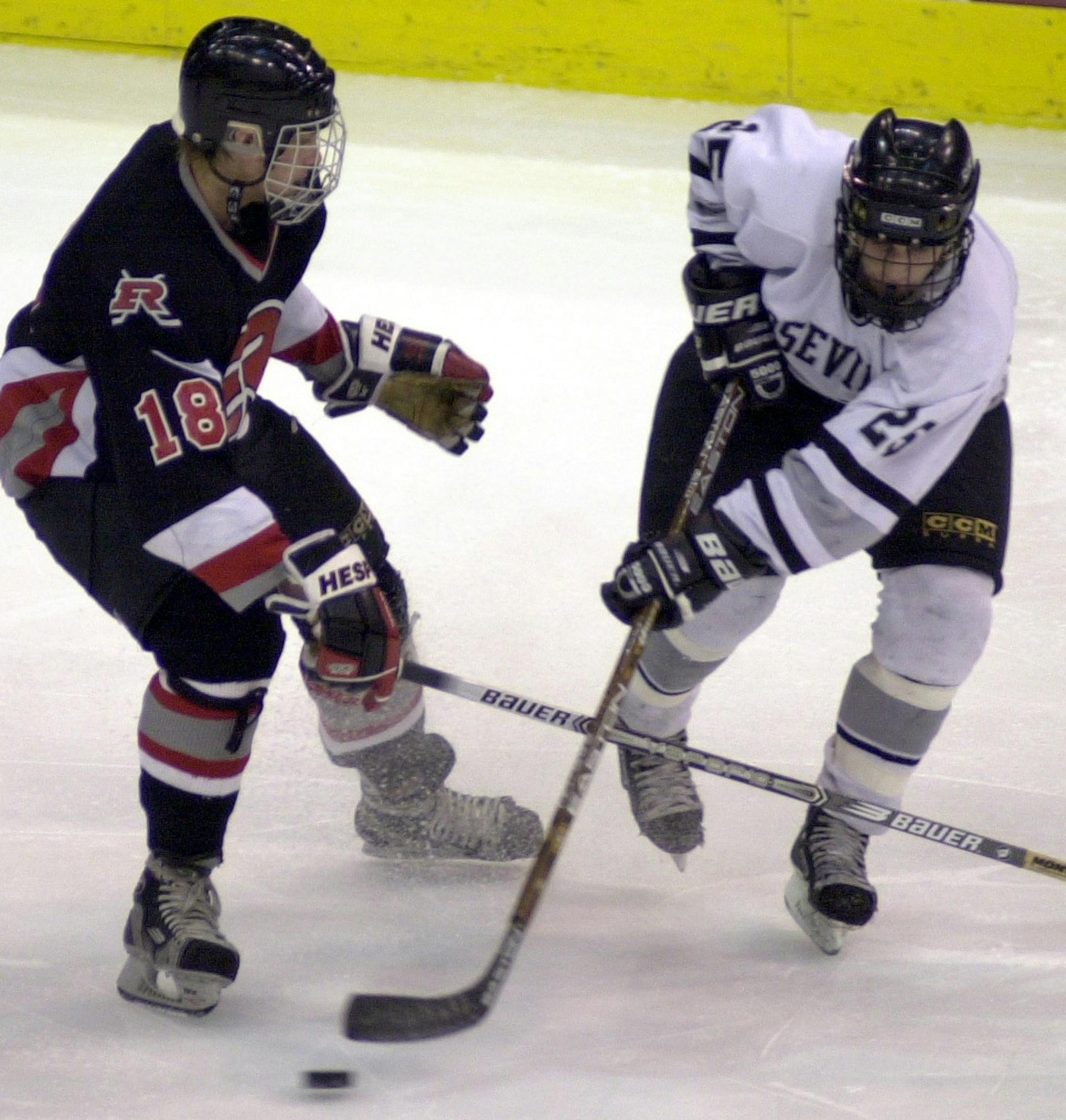 Dominic Morris, left, honed his hockey skills as a defenseman on the Elk River team that won the 2002 Class 2A state tournament consolation championship. He later played for Iowa State’s club team.