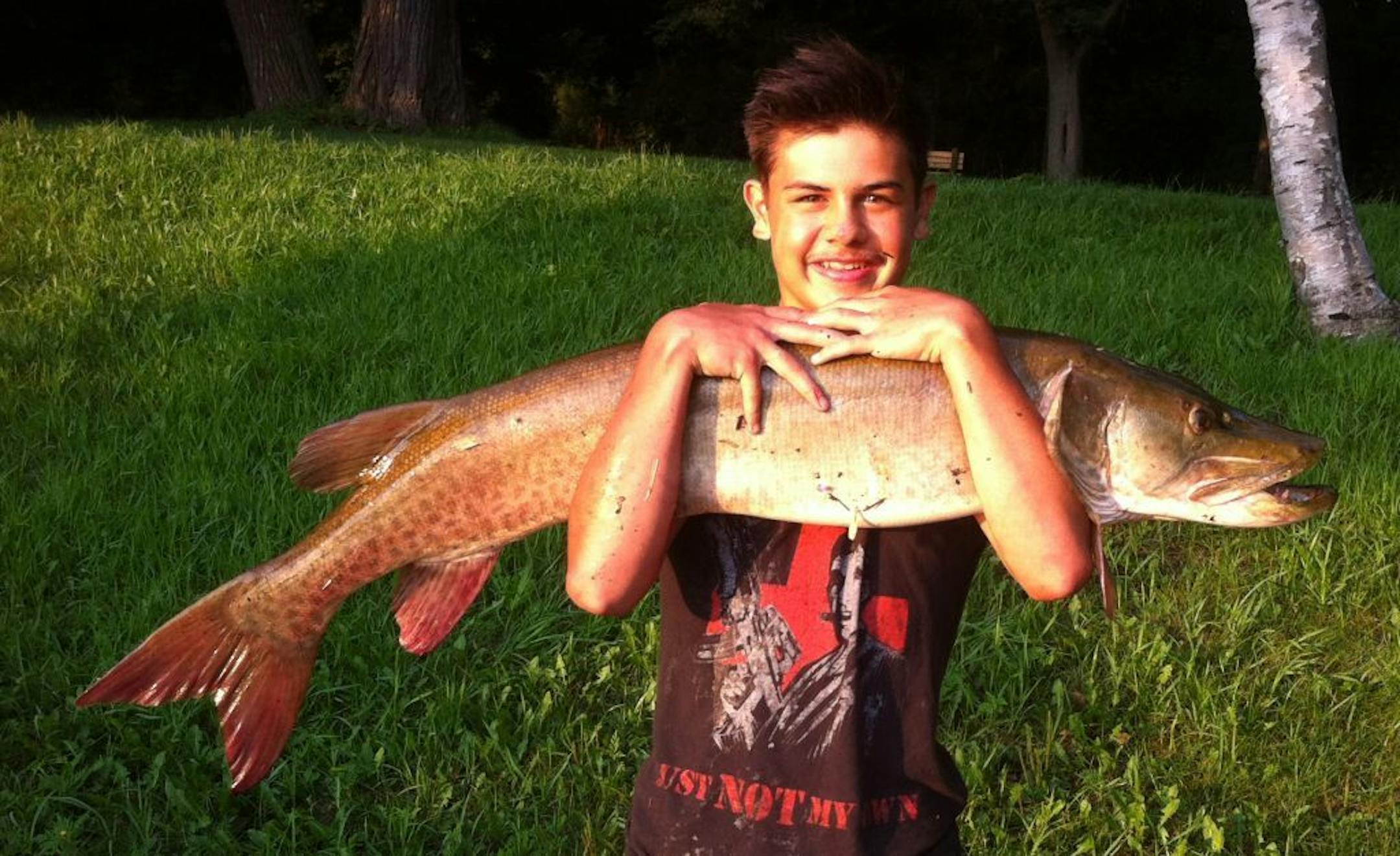 Stosh Karney, 14, and his 52-inch muskie at Cedar Lake in Minneapolis.