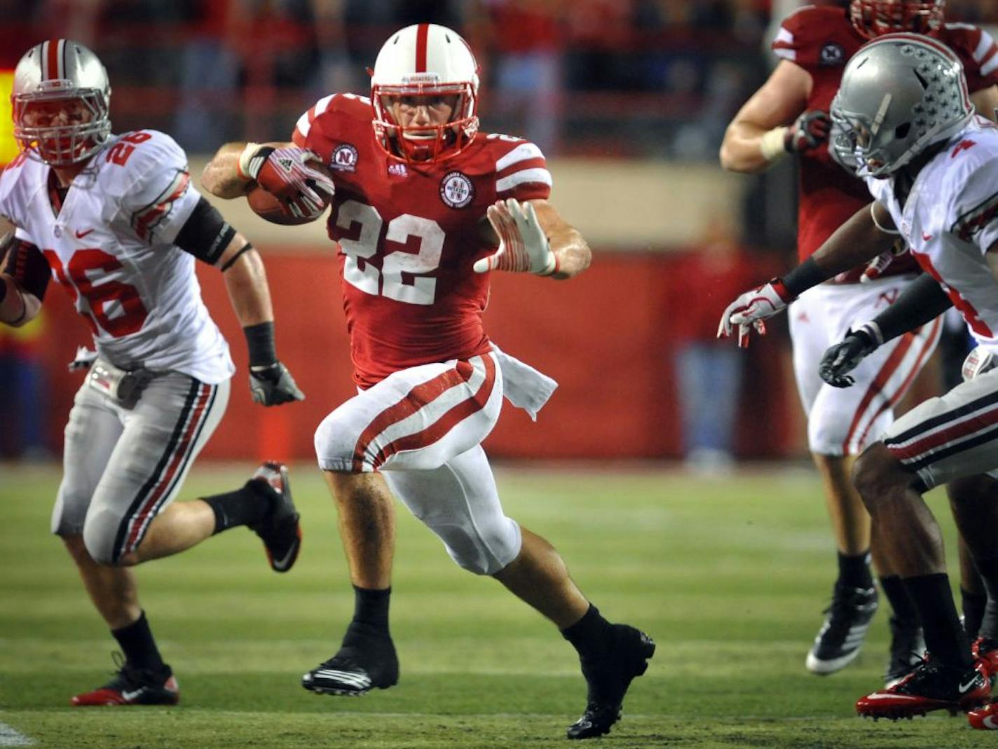 Nebraska's Rex Burkhead (22) gets by Ohio State's C.J. Barnett (4) during their NCAA college football game, Saturday, Oct. 8, 2011, in Lincoln, Neb.