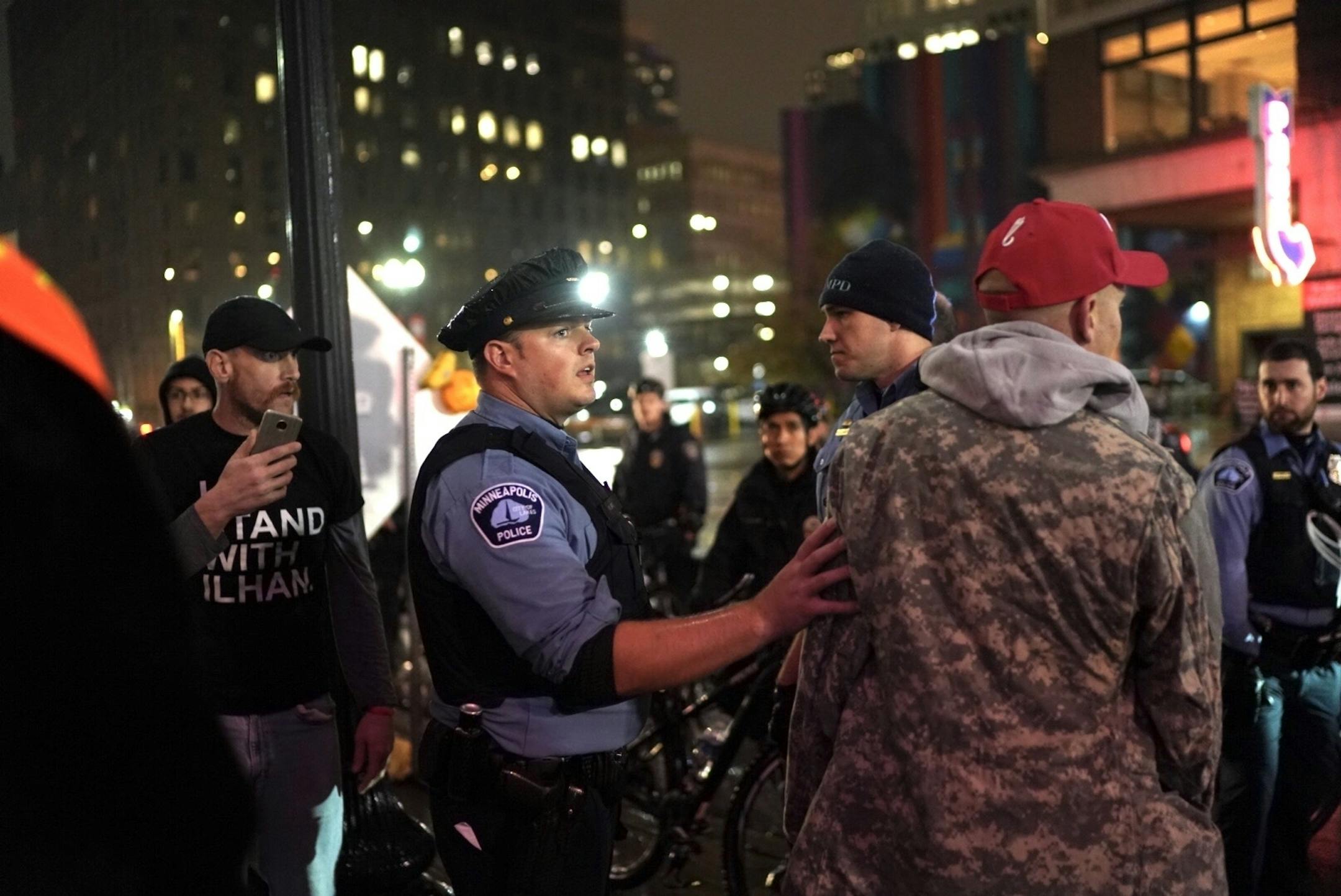 An officer got in between a protester and a Trump supporter as that approached each other angry outside the Target Center as President Donald Trump visits Minneapolis, Minn., for a campaign rally on October 10, 2019.