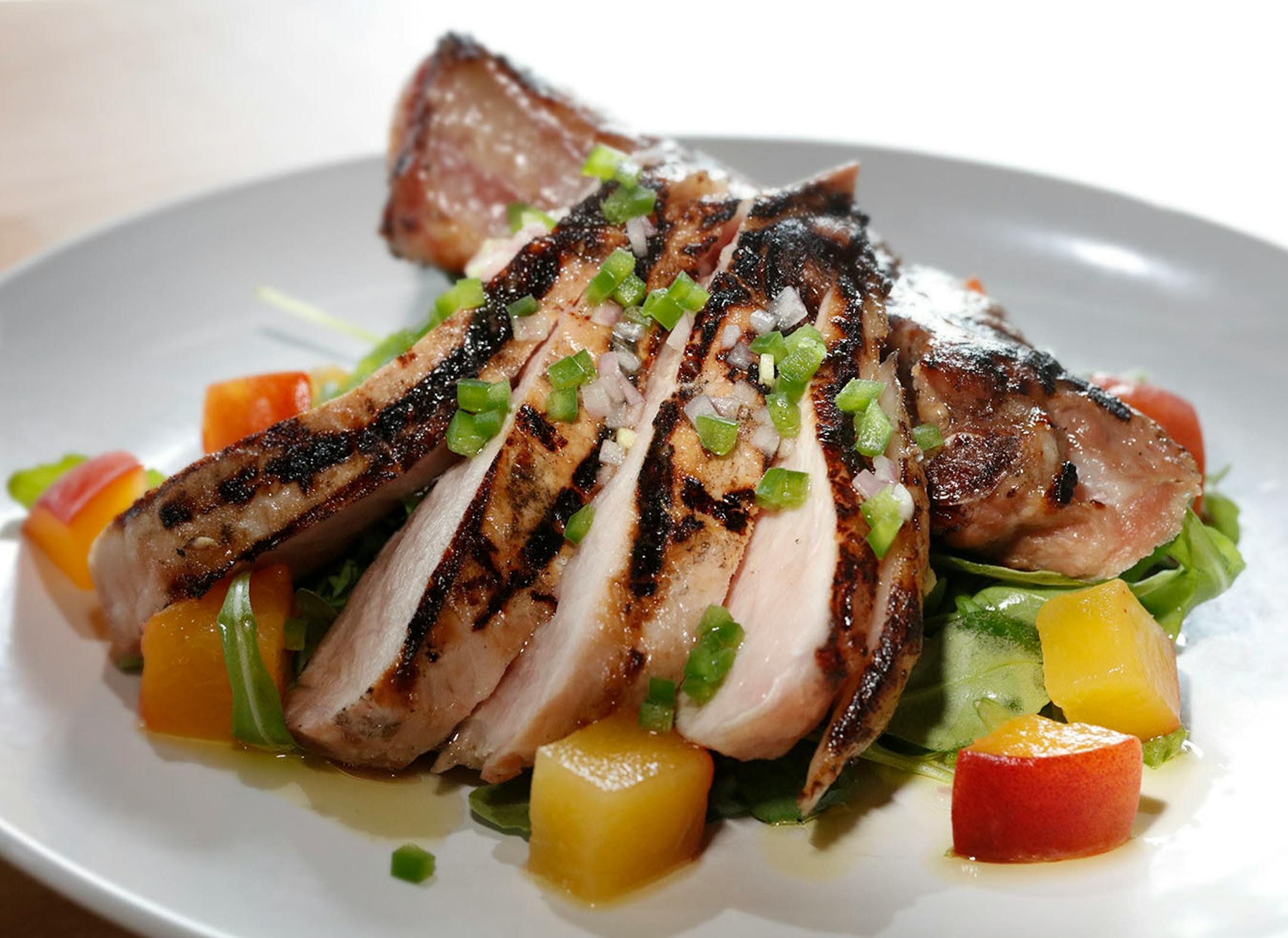 Lemongrass marinated pork loin with a crunchy peach and arugula salad.