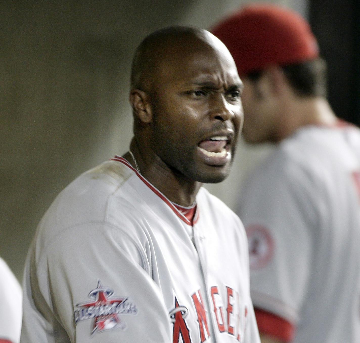 Los Angeles Angels' Torii Hunter continues to yell in the dugout after being ejected by home plate umpire Ron Kulpa after arguing when he was called out on strikes in the eighth inning of a baseball game Friday, Aug. 6, 2010, in Detroit. (AP Photo/Duane Burleson)