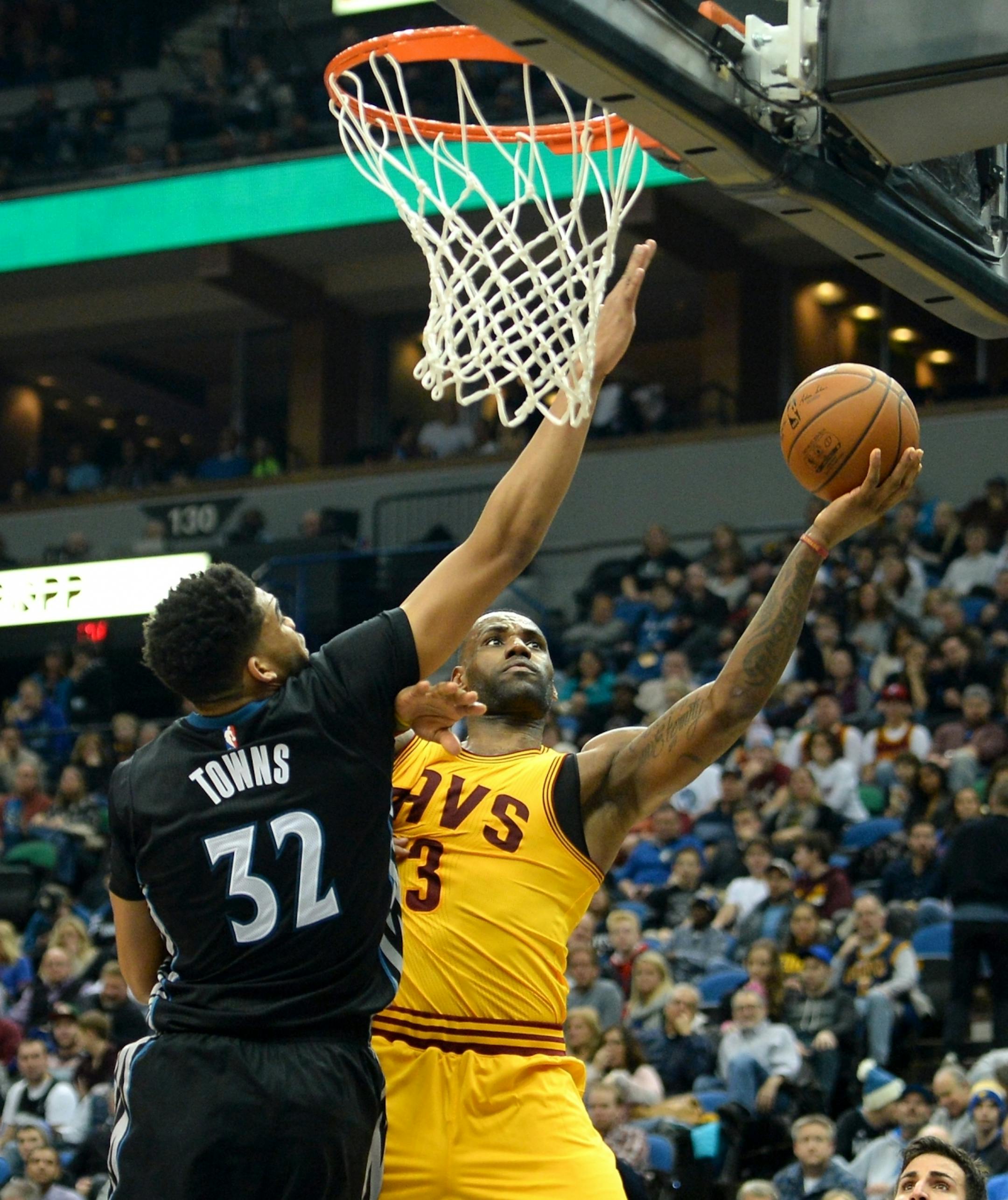 Cleveland Cavaliers forward LeBron James (23) powered past Minnesota Timberwolves center Karl-Anthony Towns (32) for a layup in the second half.