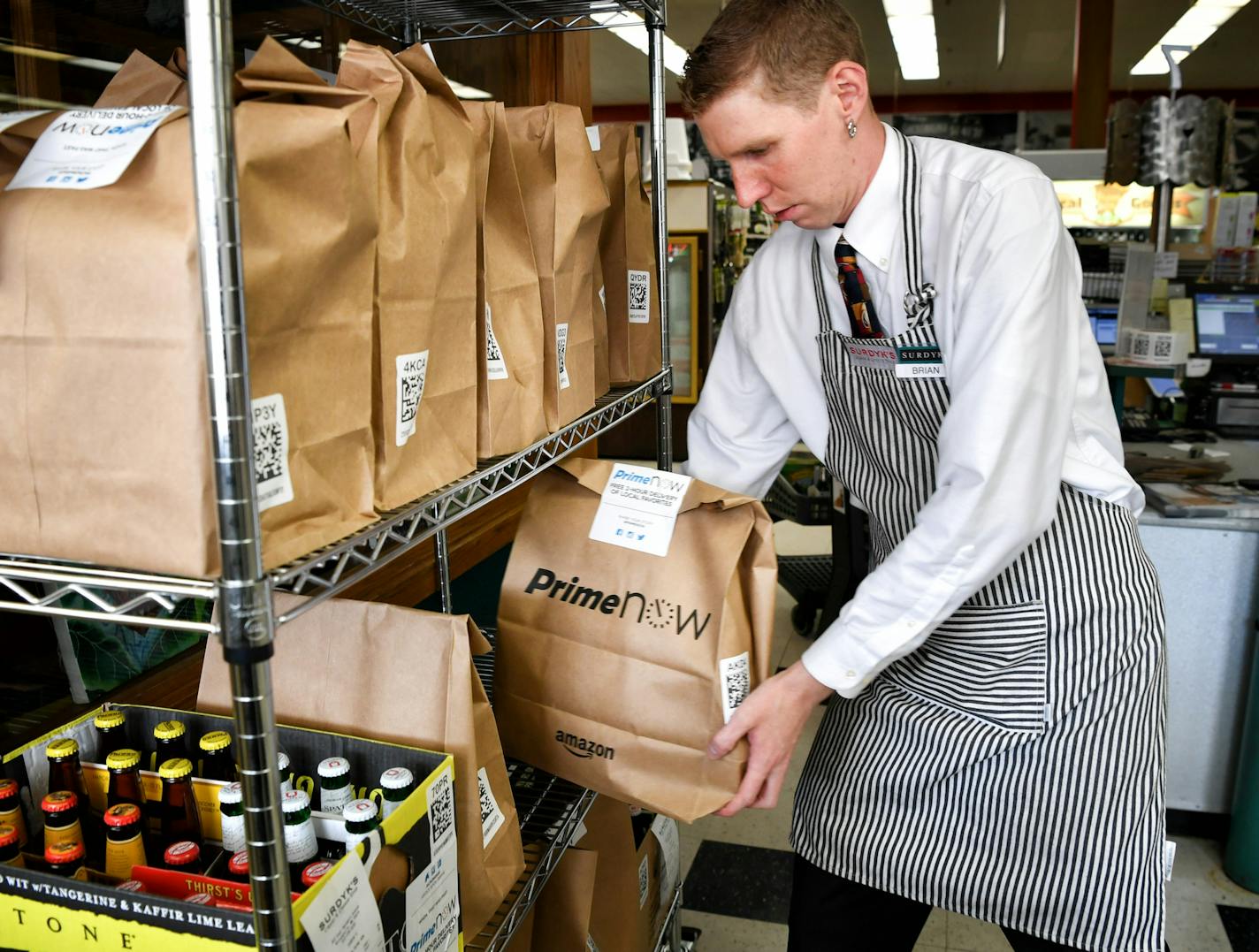 Brian Krause, delivery manager for Surdyk's said they have prepared over 200 deliveries on their first full day of offering two hour service through Amazon Prime. ] GLEN STUBBE * gstubbe@startribune.com Thursday, July 28, 2016 Amazon does its first alcohol deliveries in the Twin Cities. Workers at Surdyk's Liquor & Cheese Shop are now fulfilling delivery orders for Amazon.com's Prime Now service. They pick bottles and cans from shelves and put them in special bags. EDS. Brian Krause is pictured