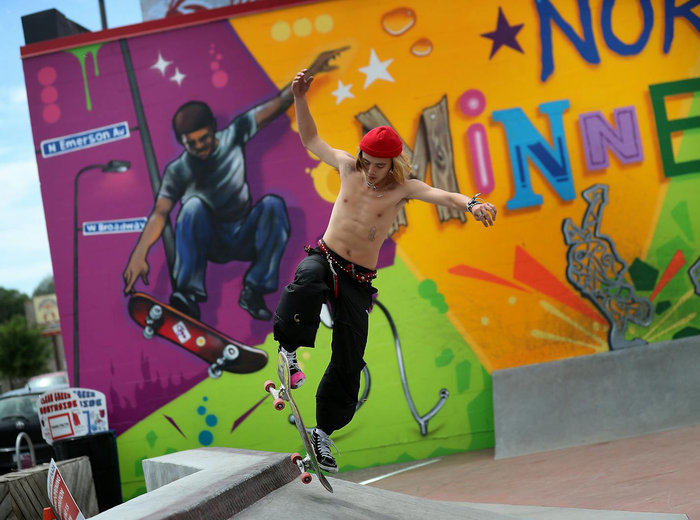 Blake Vang, 21, of Lake Elmo, tried out a quarter-pipe at the new skate-able art park in north Minneapolis, his moves echoed by a mural by New York's Tats Cru.