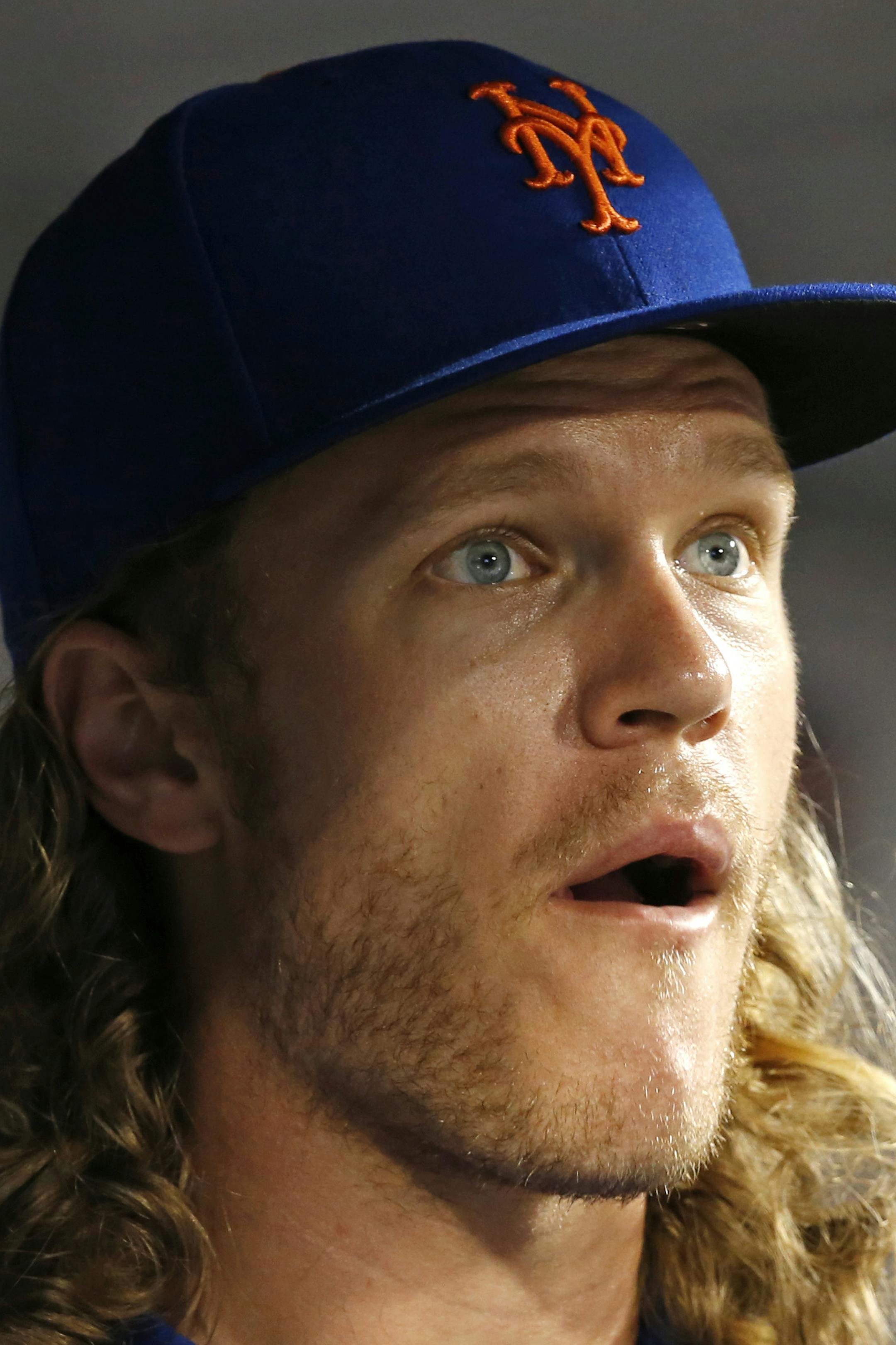 New York Mets starting pitcher Noah Syndergaard, who is on the disabled list, reacts watching a replay from the dugout during the Mets' baseball game against the St. Louis Cardinals, Monday, July 17, 2017, in New York. Syndergaard and Matt Harvey played catch together at Citi Field, their first steps toward returning to the mound for the Mets. (AP Photo/Kathy Willens) ORG XMIT: NYM205