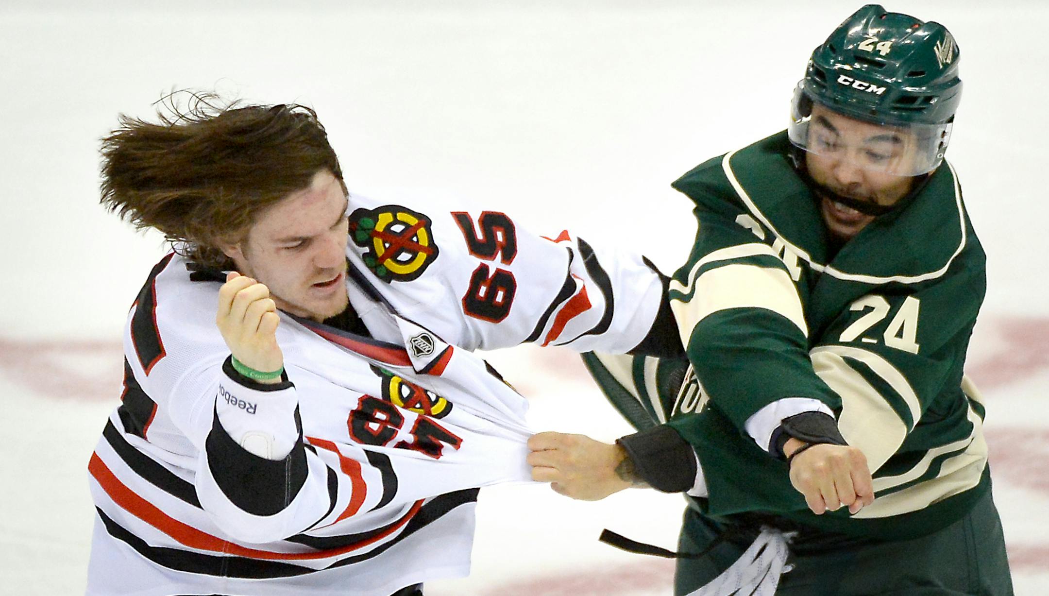 Chicago Blackhawks center Andrew Shaw (65) and Minnesota Wild defenseman Matt Dumba (24) fought in the second period. ] (AARON LAVINSKY/STAR TRIBUNE) aaron.lavinsky@startribune.com The Minnesota Wild played the Chicago Blackhawks on Tuesday, March 29, 2016 at Xcel Energy Center in St. Paul, Minn.