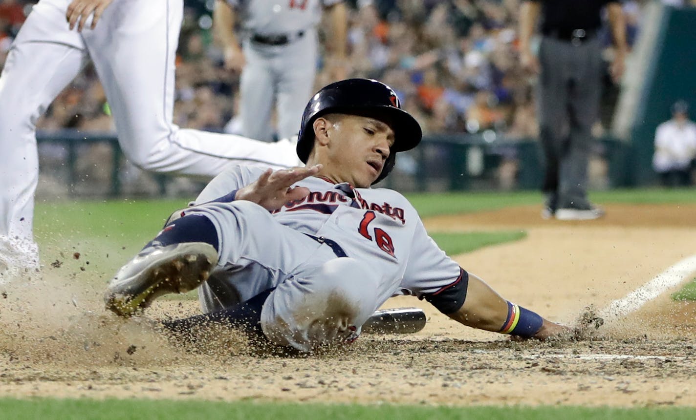 Minnesota Twins' Ehire Adrianza scores during the eighth inning of a baseball game against the Detroit Tigers, Saturday, Sept. 23, 2017, in Detroit. (AP Photo/Carlos Osorio)