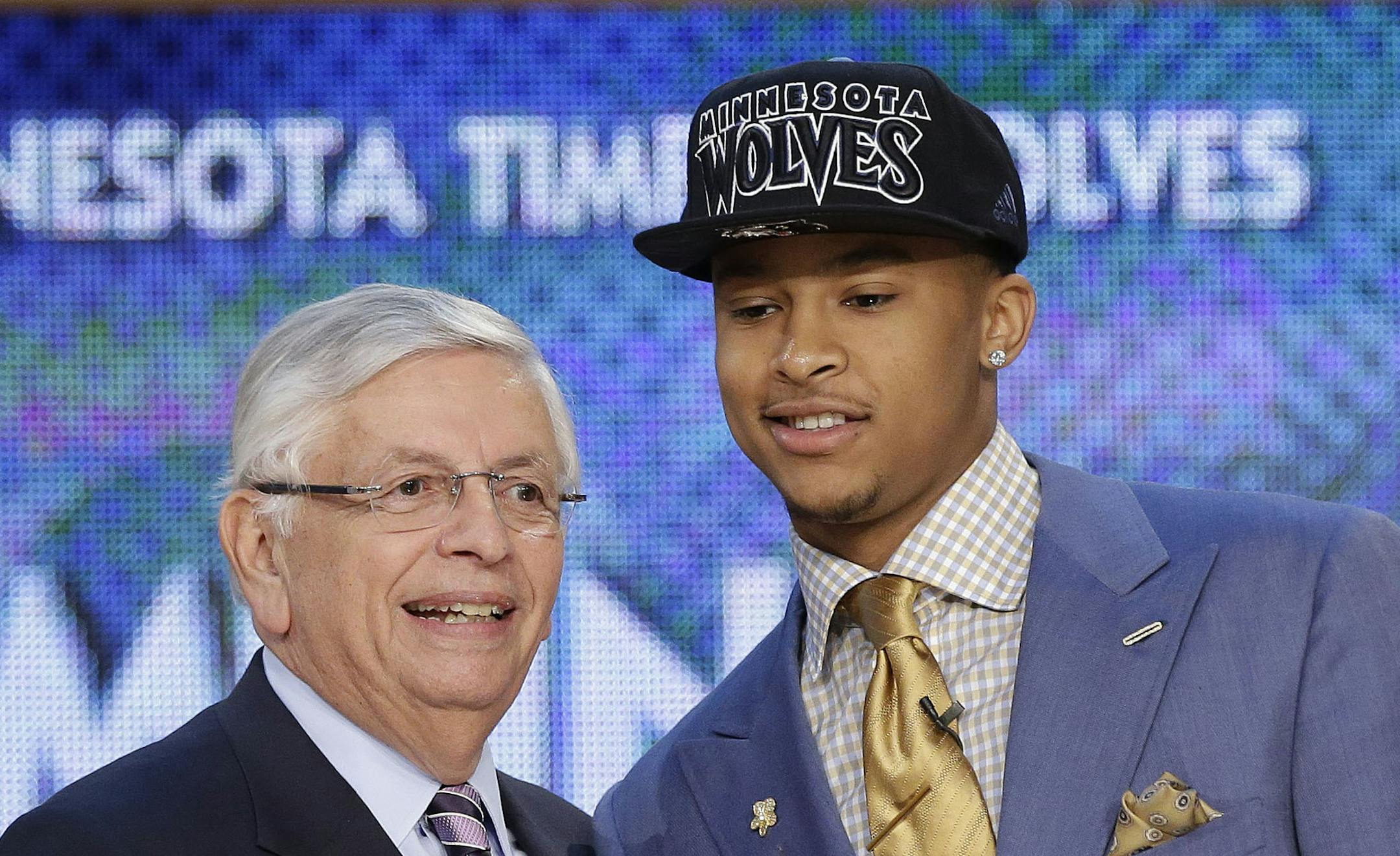 NBA Commissioner David Stern, left, shakes hands with Michigan's Trey Burke, who was selected by the Sacramento Kings in the first round of the NBA basketball draft, Thursday, June 27, 2013, in New York. (AP Photo/Kathy Willens)