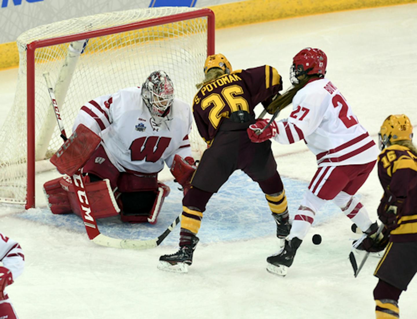 Wisconsin goaltender Kristen Campbell (35) knocks the puck away after a shot on goal by Minnesota's Sarah Potomak (26) during the third period in the NCAA Division I women's Frozen Four hockey championship game, Sunday, March 24, 2019, in Hamden, Conn. (AP Photo/Stephen Dunn)