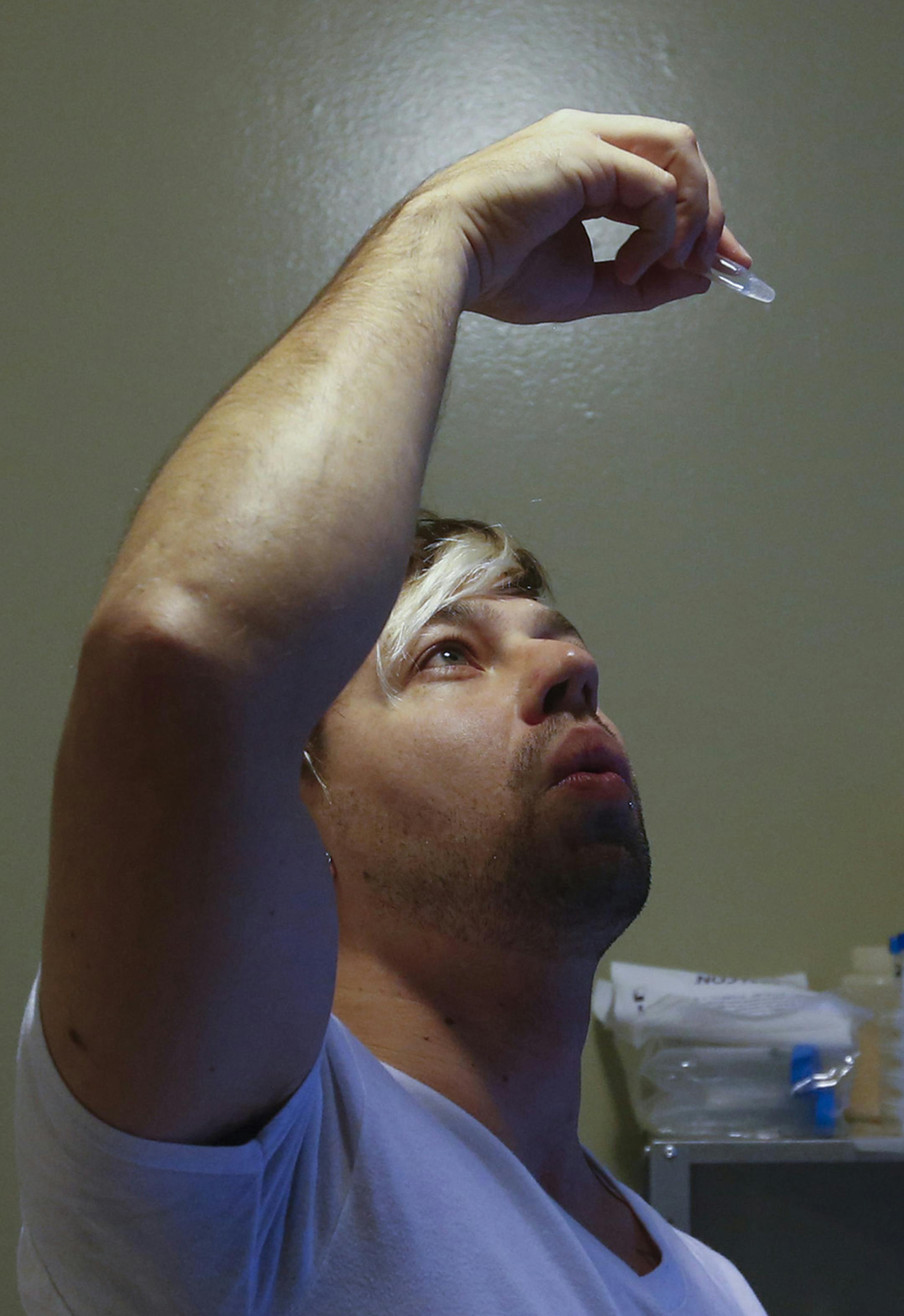 Scientist Josiah Zayner, 34, looks at the genetically engineered bacteria to make sure it is mixed well, in his home lab on Dec. 15, 2015 in Burlingame, Calif. (John Green/Bay Area News Group/TNS)