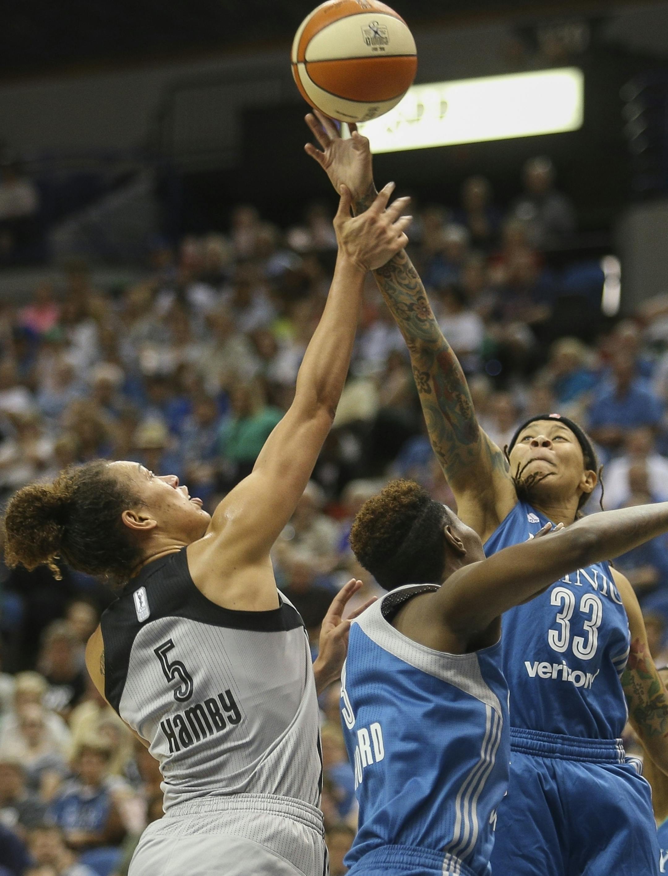 Minnesota Lynx guard Seimone Augustus (33) contests for a rebound over San Antonio Stars forward Dearica Hamby (5).