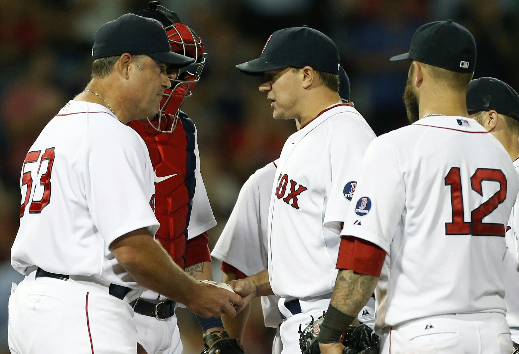 Boston Red Sox's Jake Peavy, center, hands the ball to manager John Farrell (53) as he is taken out of an interleague baseball game in the eighth inning against the Arizona Diamondbacks in Boston, Saturday, Aug. 3, 2013. (AP Photo/Michael Dwyer)