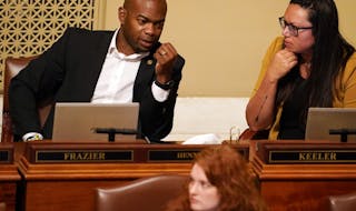 Freshman Rep. Cedrick Frazier, DFL-New Hope, talked with fellow state Rep. Heather Keeler, DFL-Moorhead, on the House floor during a special session T