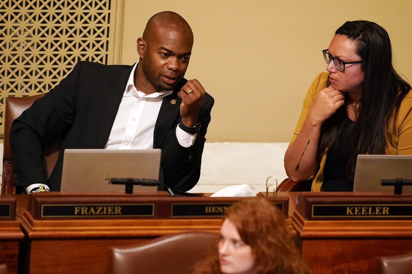 Freshman Rep. Cedrick Frazier, DFL-New Hope, talked with fellow state Rep. Heather Keeler, DFL-Moorhead, on the House floor during a special session Thursday. ] ANTHONY SOUFFLE • anthony.souffle@startribune.com