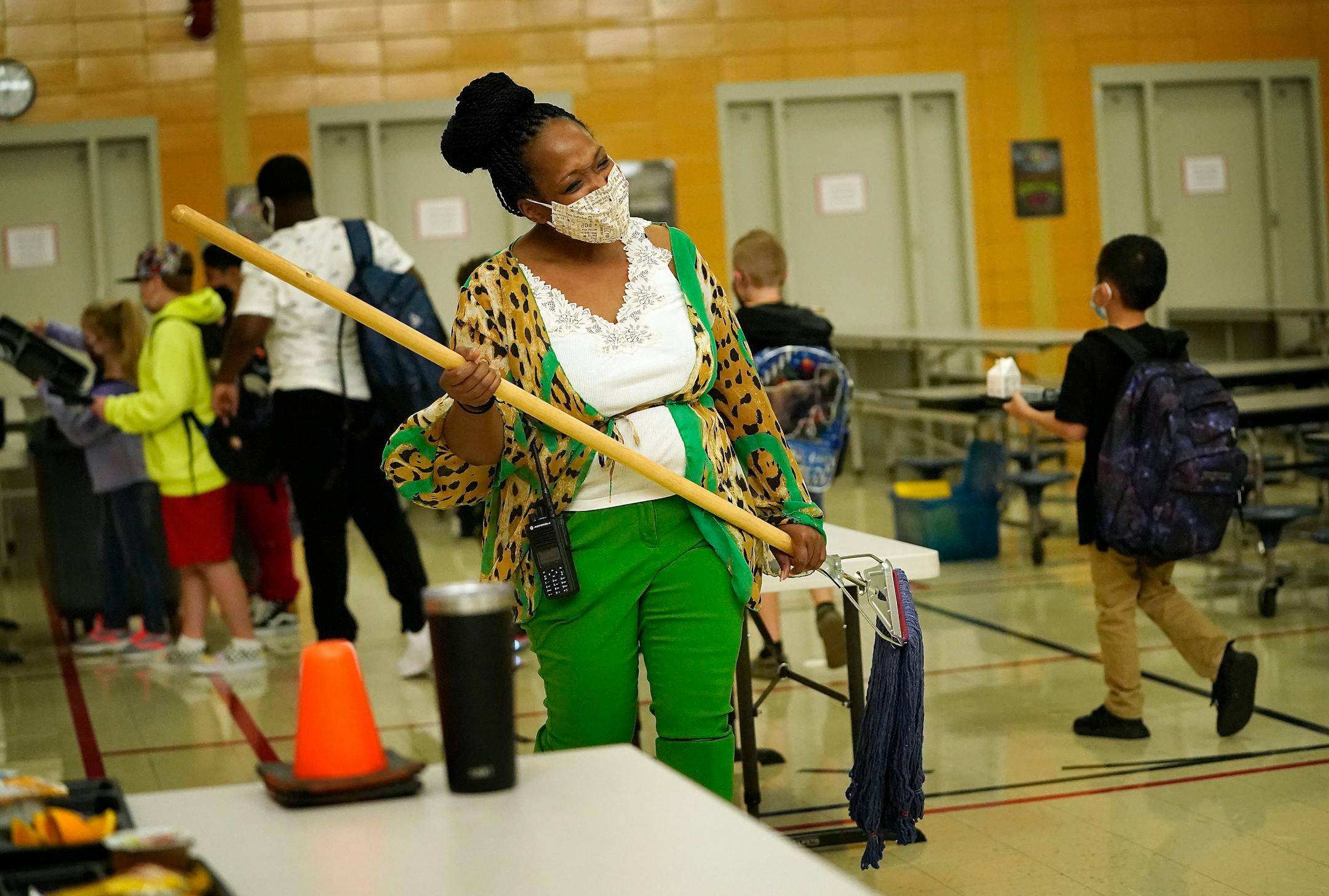 New Hoover Elementary School principal Keisha Davis acted as custodian while grabbing a mop to clean up a spill in the lunchroom during morning breakfast before the start of the first day of school Tuesday in Coon Rapids.   ]