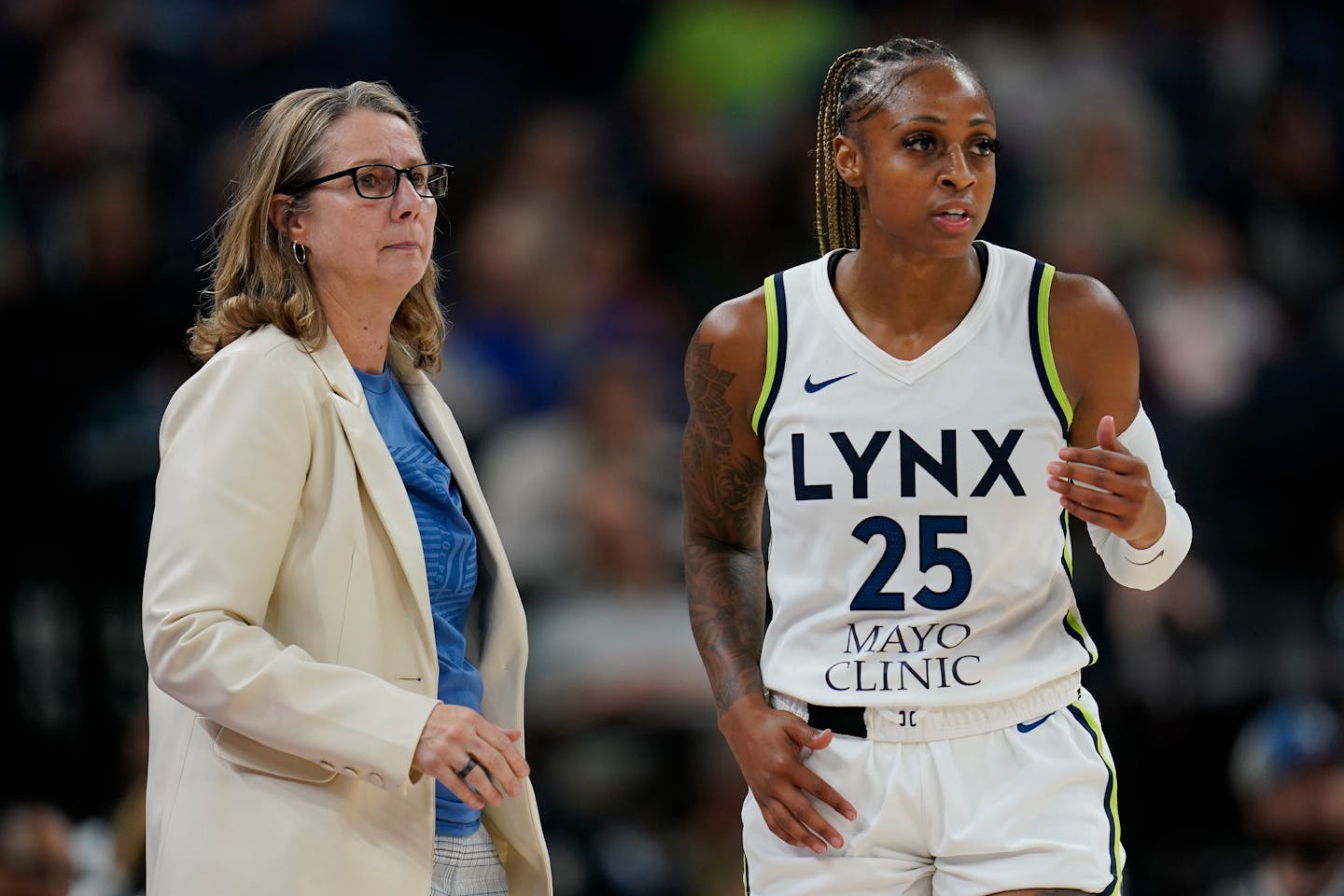 Minnesota Lynx head coach Cheryl Reeve, left, and guard Tiffany Mitchell (25) look on during the second half of a WNBA basketball game against the Los Angeles Sparks, Sunday, June 11, 2023, in Minneapolis. (AP Photo/Abbie Parr)