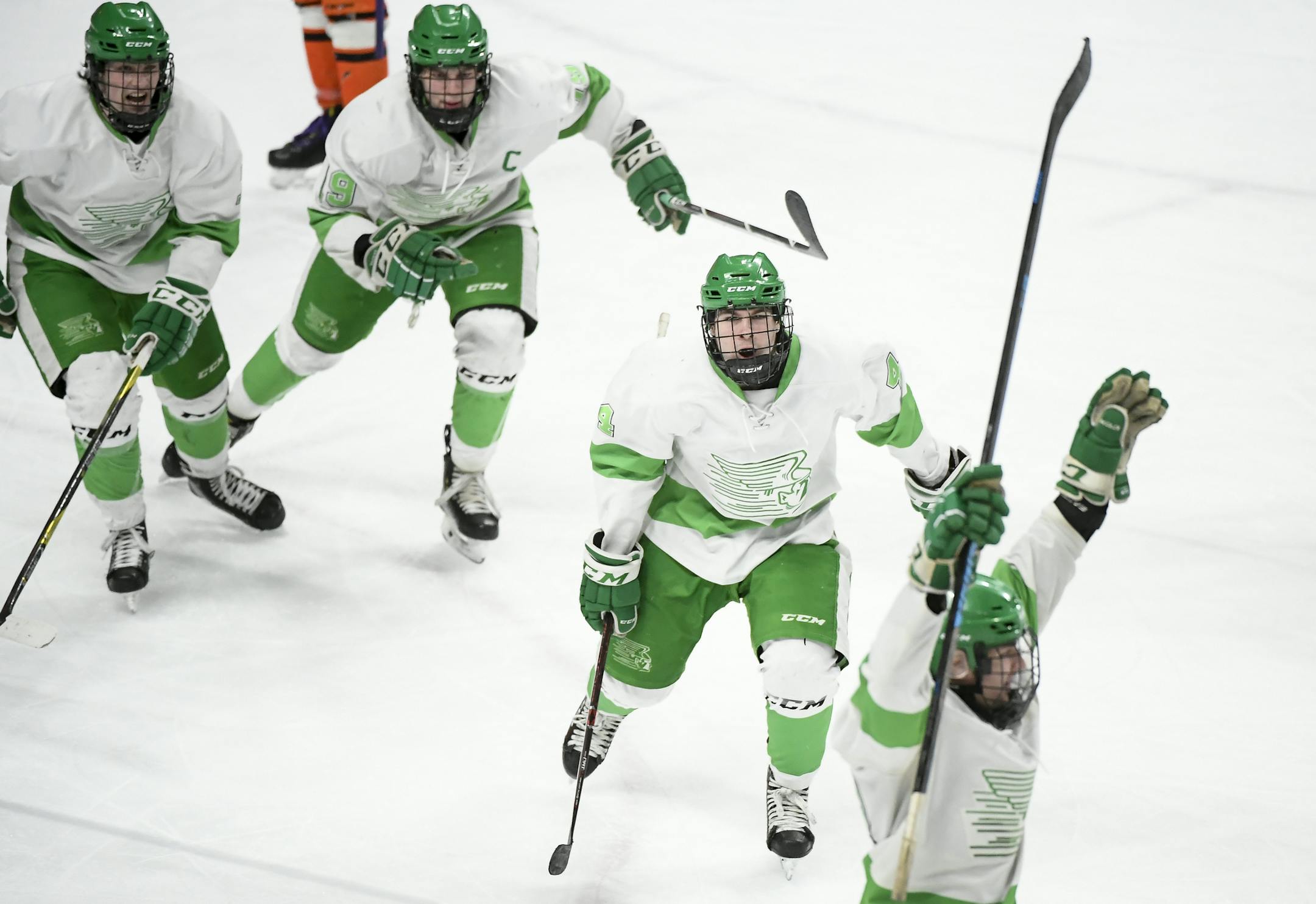 Teammates celebrated with Greenway/Nashwauk-Keewatin defenseman Christian Miller (12), bottom right, after his go-ahead goal in the third period, giving their team a 5-4 lead against Delano. ] Aaron Lavinsky ¥ aaron.lavinsky@startribune.com Delano played Greenway in a Class 1A quarterfinal hockey game on Wednesday, March 6, 2019 at the Xcel Energy Center in St. Paul, Minn.