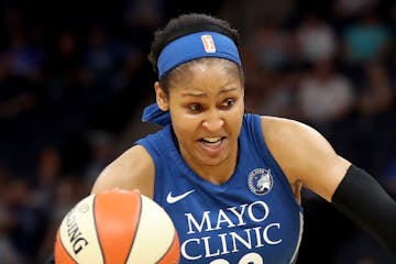 The Minnesota Lynx Seimone Augustus (33) dribbles by the Phoenix Mercury's Diana Taurasi (3) during the first quarter Friday, June 1, 2018, at the Tar