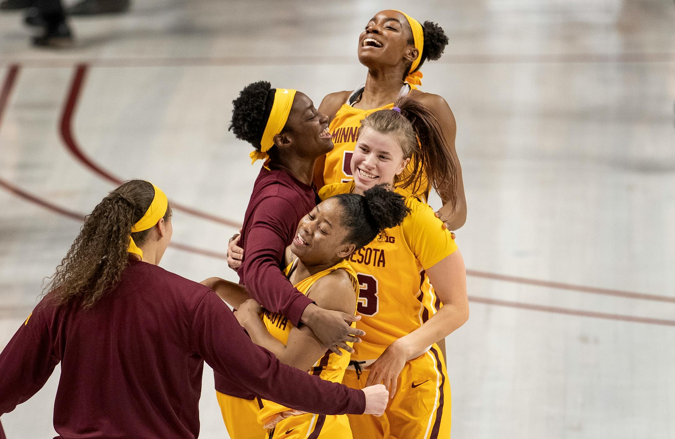 Gophers players Taiye Bello (5), Masha Adashchyk (23) and Jasmine Powell (4) celebrated a victory over Nebraska on Jan. 30.