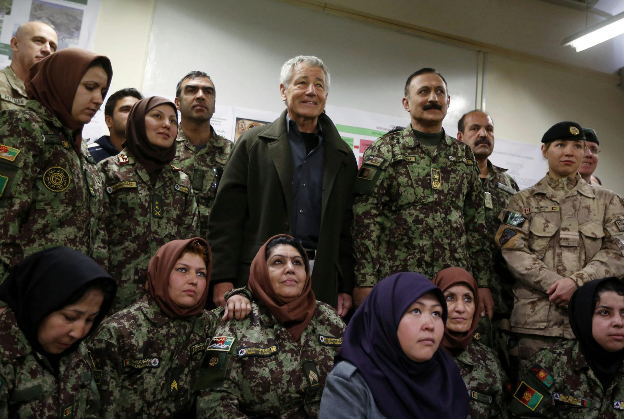 U.S. Defense Secretary Chuck Hagel , center left, poses for a picture with female Afghan non-commissioned officers being trained during his visit to the Kabul Military Training Center in Kabul, Afghanistan Sunday, March 10, 2013. Also pictured is Brig. Gen. Aminullah Patyani, center right, commander of the training center. Hagel said he believes U.S. officials will be able to work things out with Afghan leaders who have ordered special operations forces out of Wardak province, even as commandos