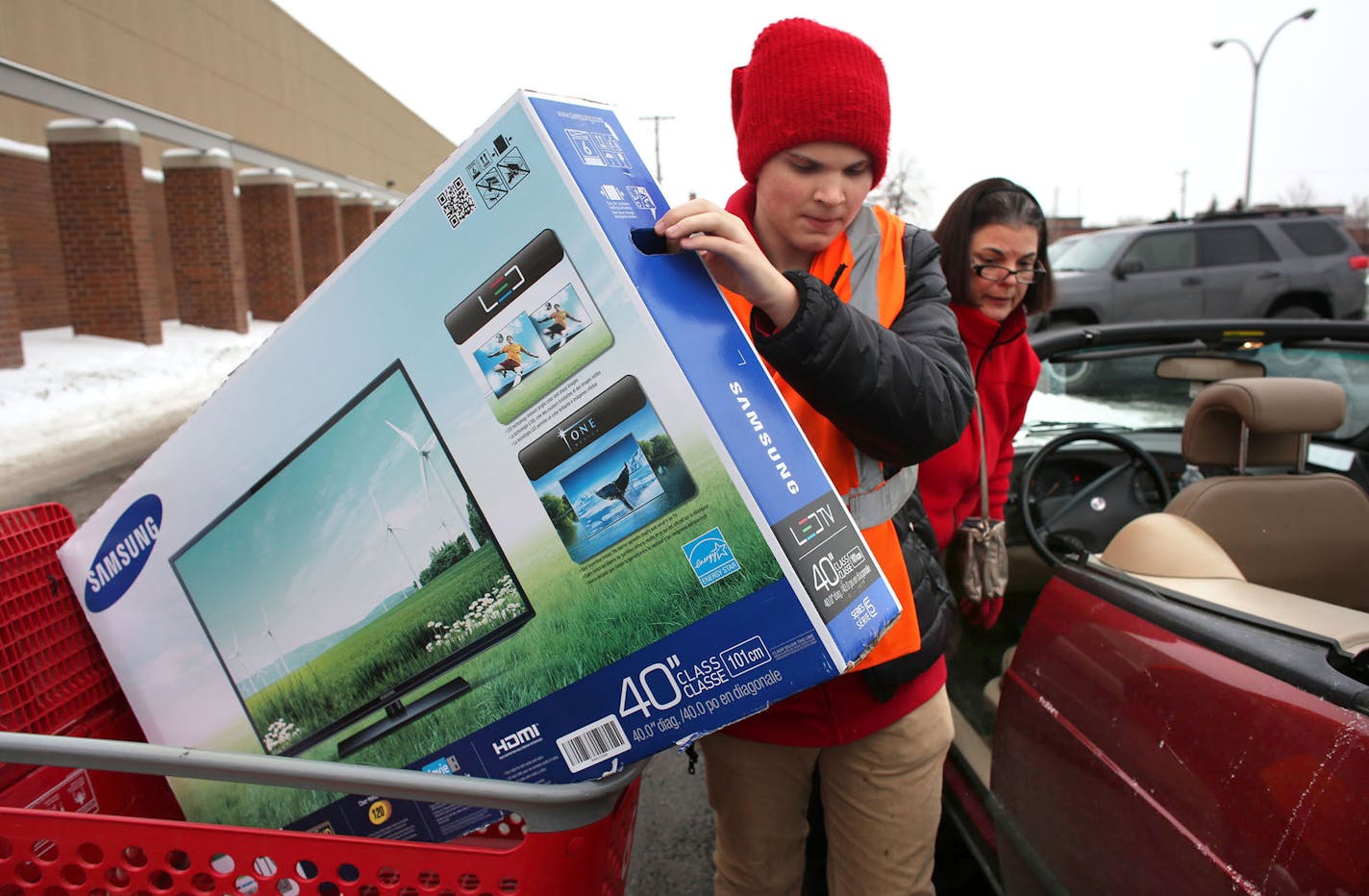 Wyatt Buchanan, Target employee, helped to put a new television in the car of Denise Dian, of Roseville, at Target in Roseville Dec. 21, 2013.