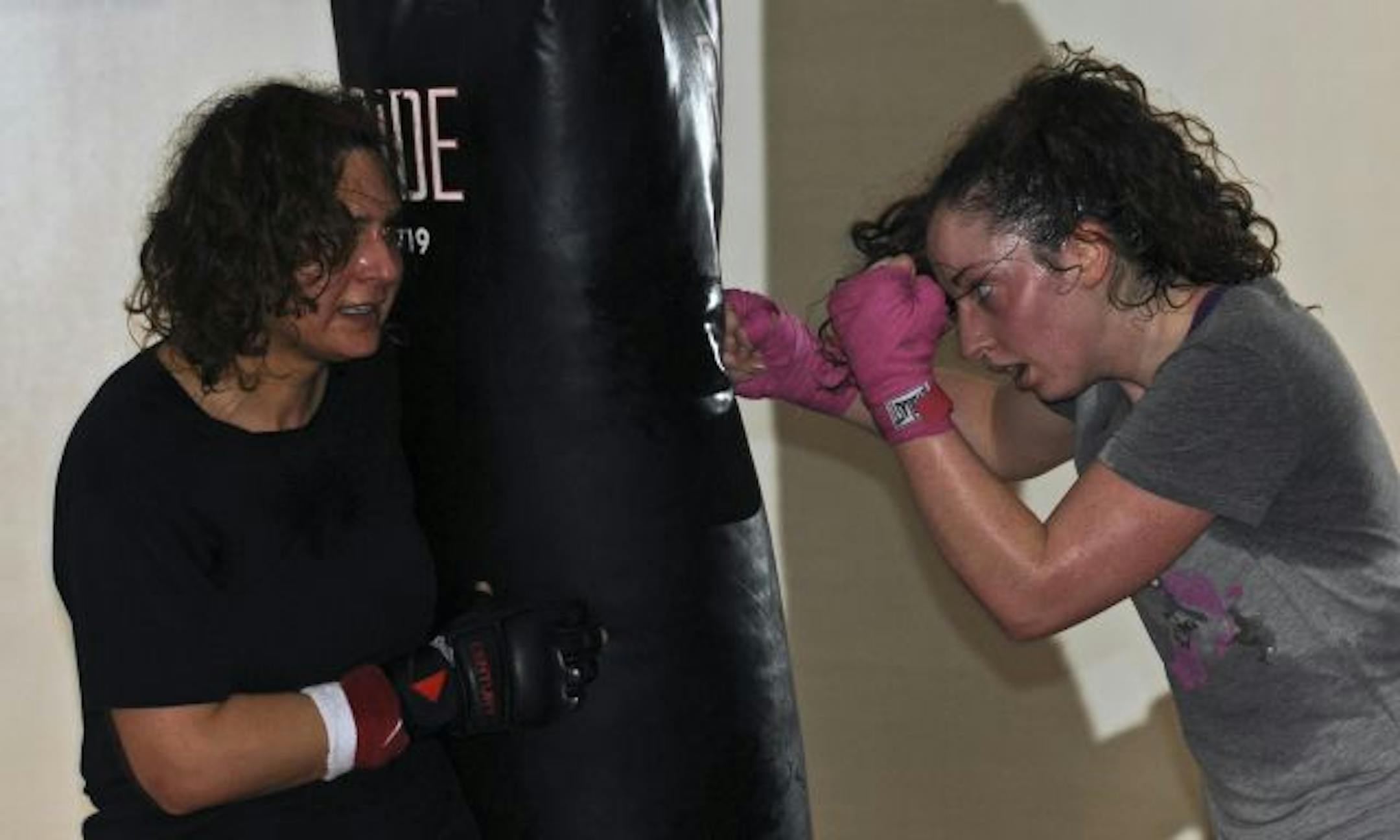 More than half of the students in the 90-minute class are women. Much of the time is devoted to building upper-body strength. Here, Cassandra Bethke punched while Ora Masheal steadied the bag.