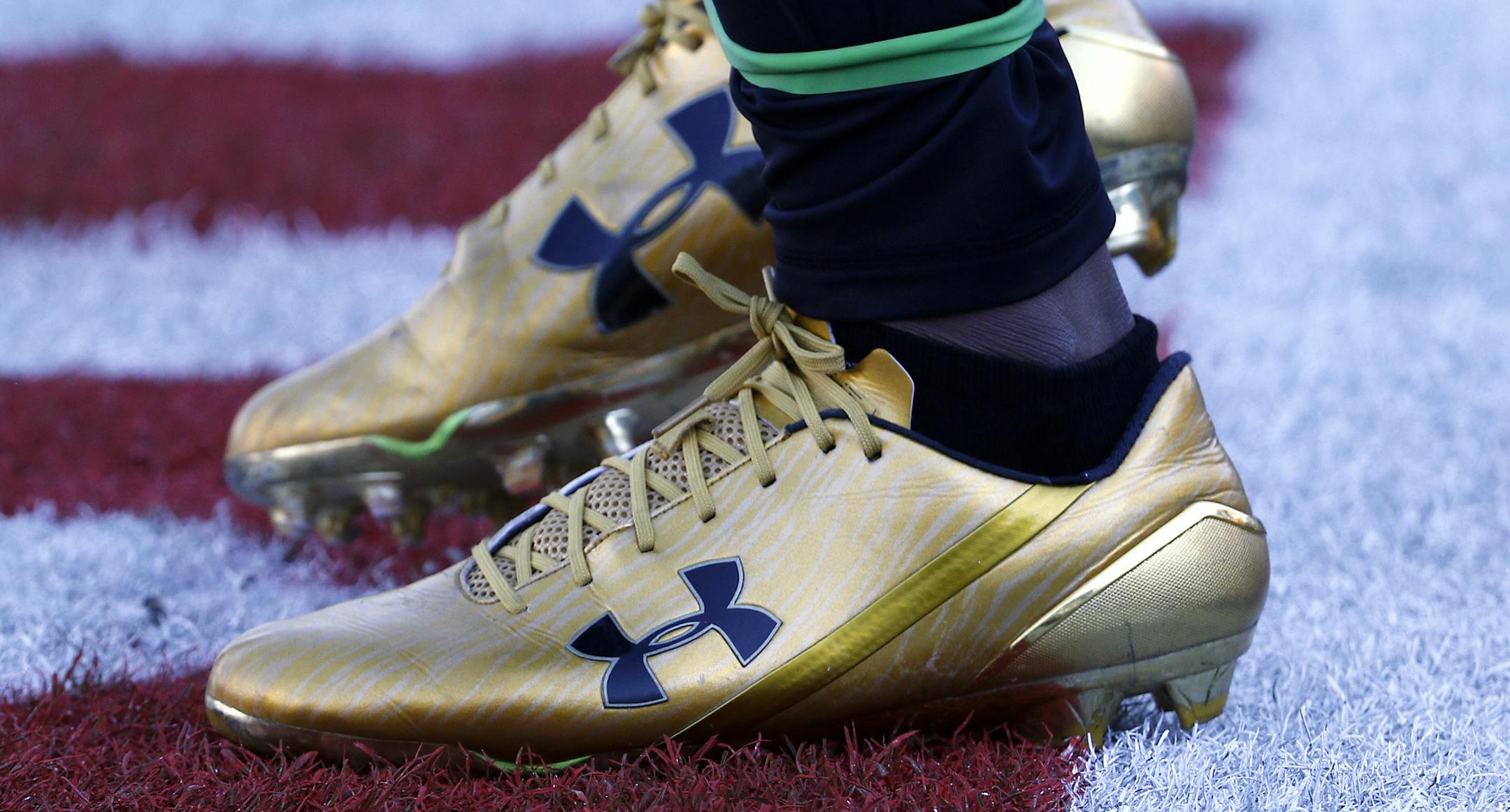 FILE- In this Dec. 10, 2017, file photo, Jacksonville Jaguars running back T.J. Yeldon warms up wearing Under Armour cleats before an NFL football game against the Seattle Seahawks in Jacksonville, Fla. Under Armour reports financial results Tuesday, Feb. 13, 2018. (AP Photo/Stephen B. Morton, File)