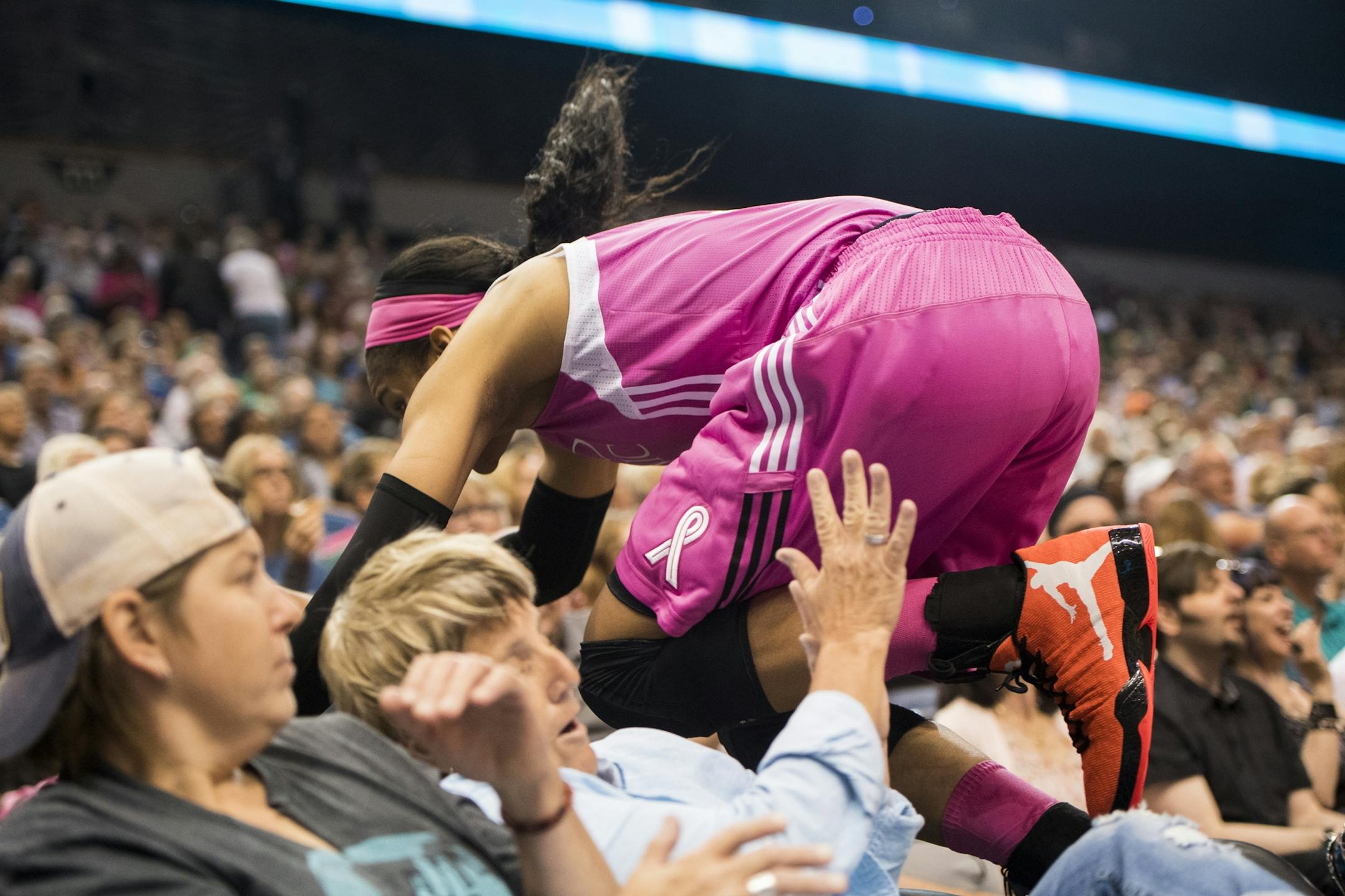 Minnesota Lynx forward Maya Moore (23) jumped into the crowd in pursuit of a loose ball.