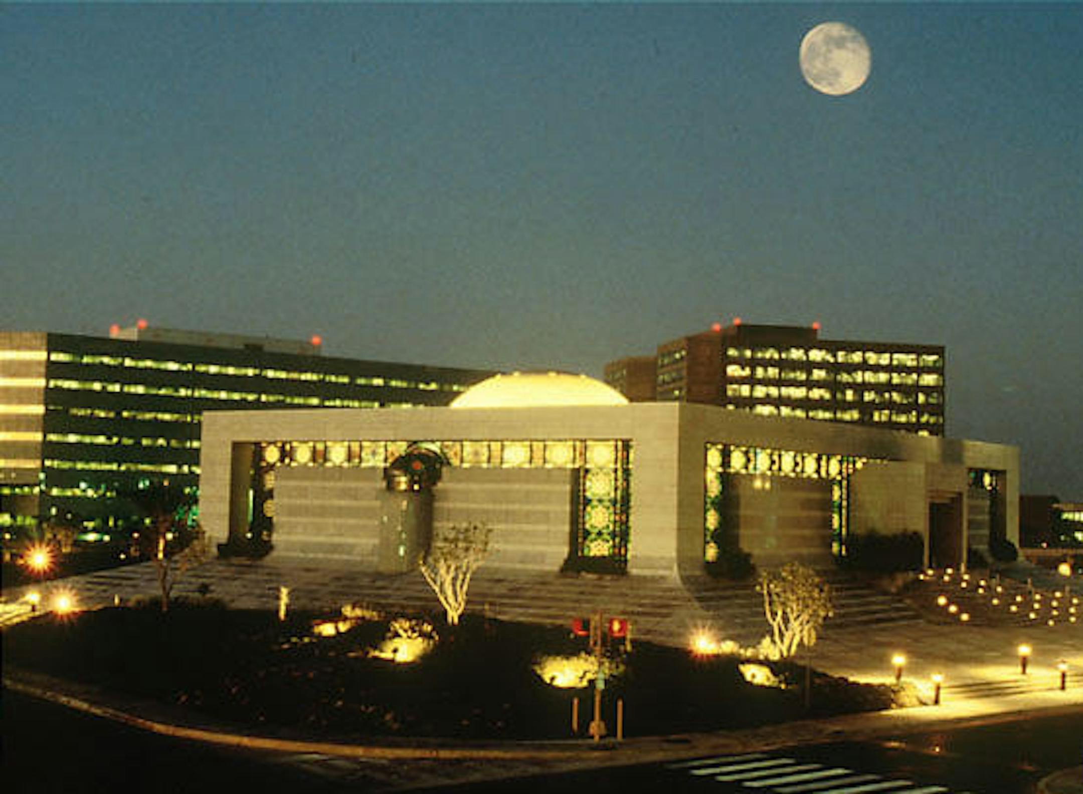 Saudi Armaco Saudi Aramco's core area which includes the headquarters and office buildings in Dhahran city. The buildings which appear in this picture are the Engineering Building, Admin Towers, Almujamma' Mosque, and the Old Administration Building. The buildings which appear in this picture are the Al Mujamma Mosque (foreground), Administration buildings (right background Two Towers), Old Admin Building (right background shown between Mosque and Minaret) and Engineering building (left backgrou
