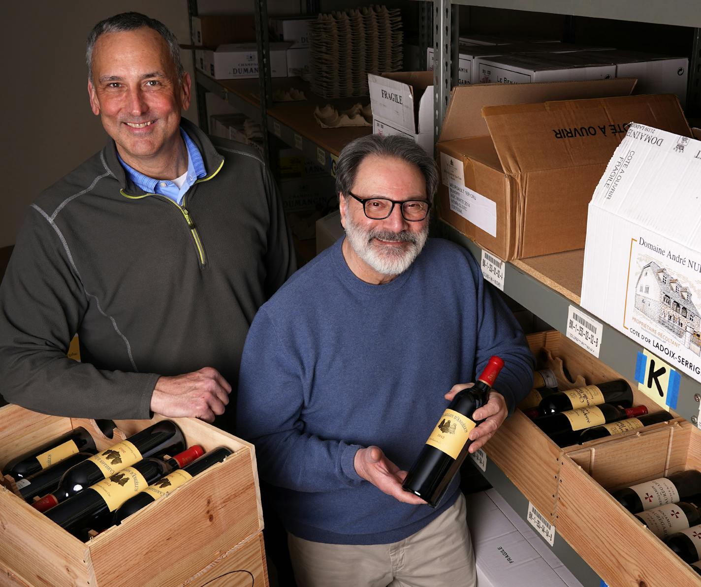 John Desteian, right, owner of Lompian Wines, a small importer of European wines, and his operations manager Mark Mueller stood for a portrait among a selection of their French wines Tuesday. ] ANTHONY SOUFFLE &#x2022; anthony.souffle@startribune.com John Desteian, owner of Lompian Wines, a small importer of European wines, stood for a portrait among a selection of his French wines Tuesday, March 3, 2020 at his company's warehouse in Fridley, Minn. The 25% tariffs on wines from France, Germany,