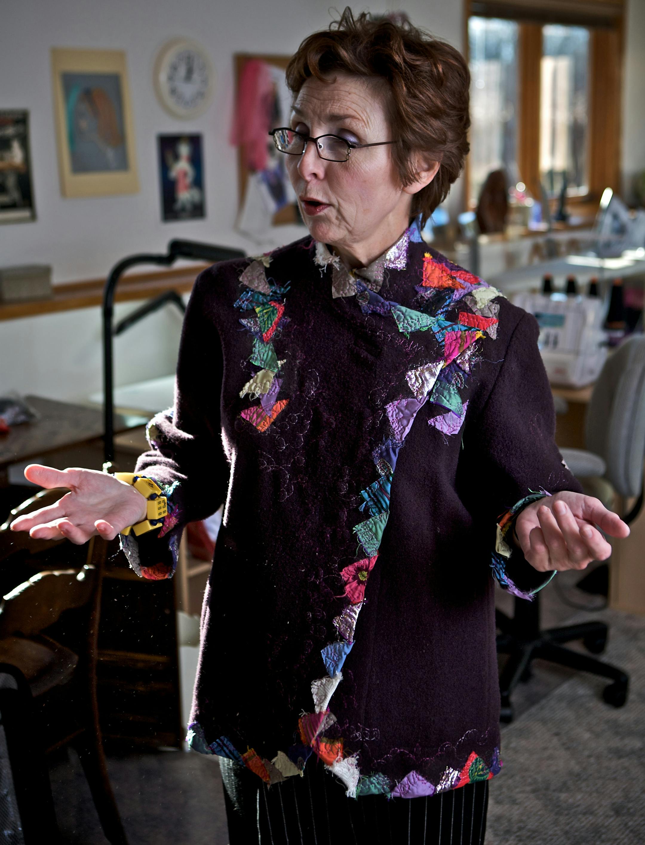 Marsha Theis models the first sweater she made eight years ago. She didn't try selling her fashions until she retired from teaching in 2005.