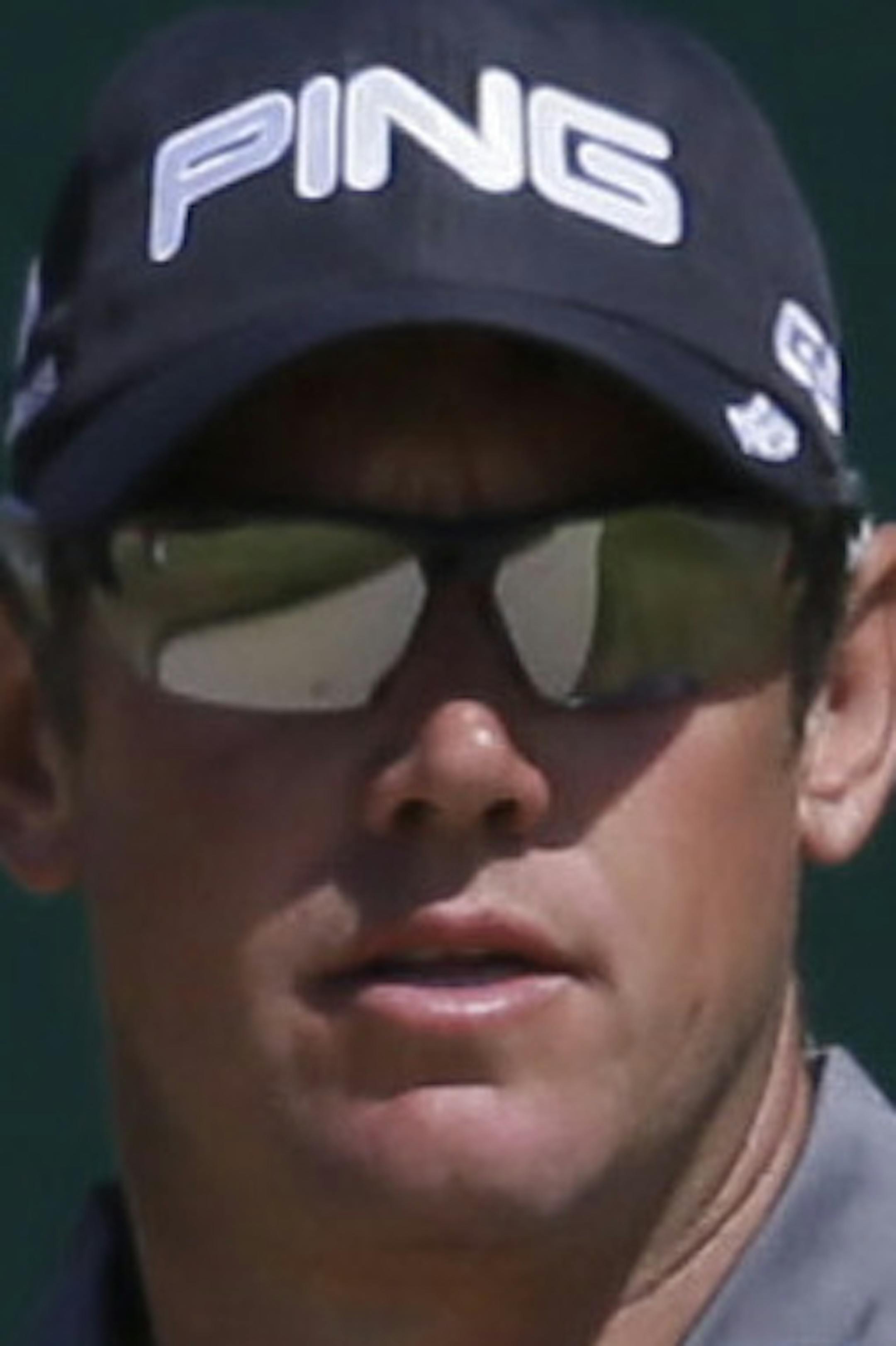 Lee Westwood of England looks at his ball on the 18th green after playing out of a bunker during the second round of the British Open Golf Championship at Muirfield, Scotland, Friday July 19, 2013. (AP Photo/Jon Super)