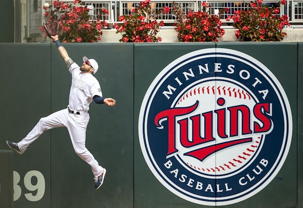 Minnesota Twins left fielder Jake Cave (60) made a full extension catch at the wall ton close out the eighth inning.