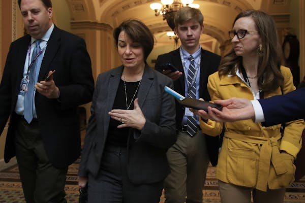 Reporters follow Sen. Amy Klobuchar, D-Minn., on Capitol Hill in Washington, Tuesday, Jan. 8, 2019, (AP Photo/Manuel Balce Ceneta)