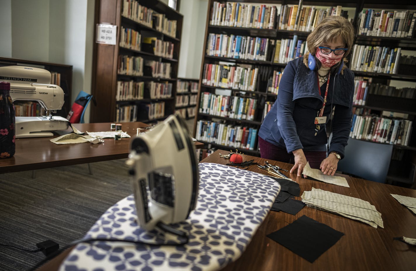 Library staffers including Kathleen Conger are sewing 2,000 cloth masks by April 22. It fills a need for protective equipment, and gives library staff work to do while branches are closed. ] St. Paul, like cities across the country, doesn't have enough masks to protect first responders from COVID-19. So the city is deputizing library staffers to sew 2,000 cloth masks by April 22. It fills a need for protective equipment, and gives library staff work to do while branches are closed. RICHARD TSONG