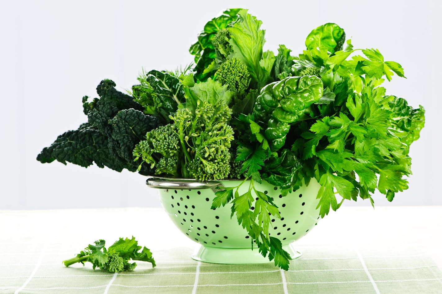 Dark leafy greens in a colander.