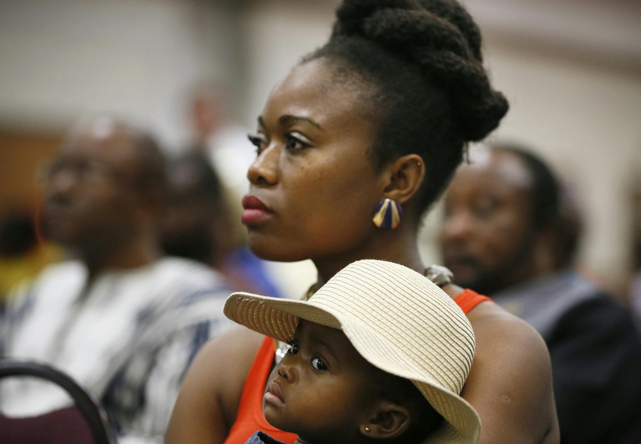 Princess Yanforh held her 1-year-old daughter Trinity Myers during a community meeting to address the ebola virus in Liberia and two other West African countries Sunday August 3 , 2014 in Brooklyn Park , MN . Princess say she his worried because most of her family still lives in Liberia. ] Jerry Holt Jerry.holt@startribune.com