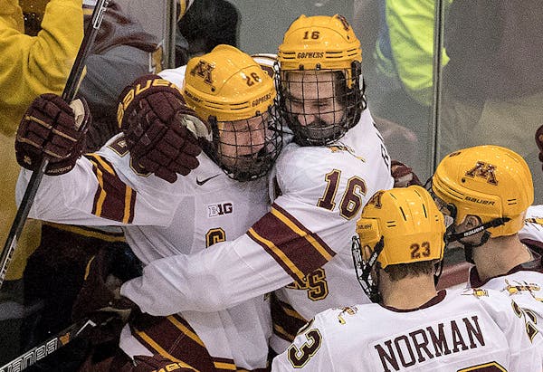Darian Romanko (26) celebrated with teammates after scoring a goal in the third period.
