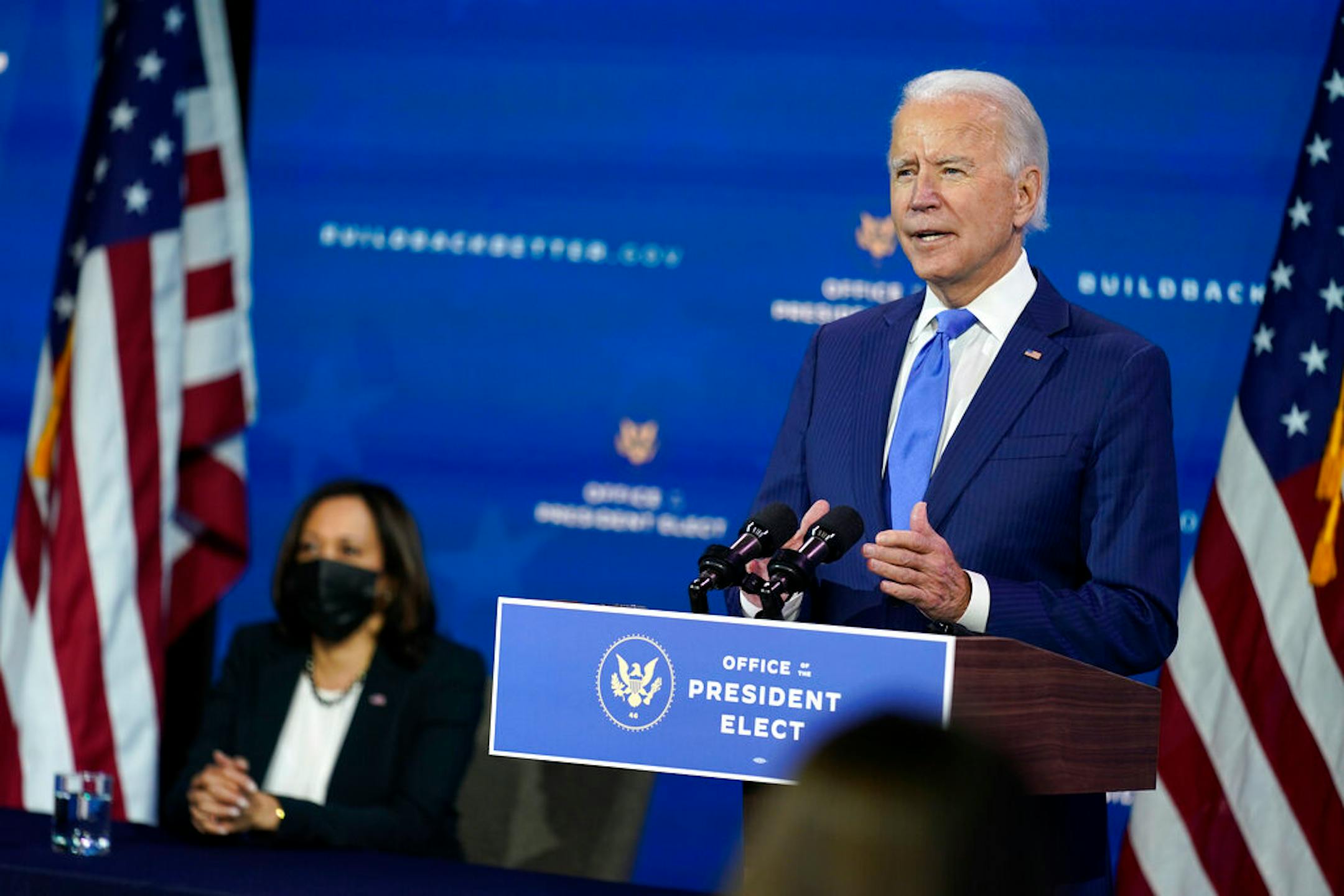 President-elect Joe Biden speaks as Vice President-elect Kamala Harris listens at left, during an event to introduce their nominees and appointees to economic policy posts at The Queen theater, Tuesday, Dec. 1, 2020, in Wilmington, Del.