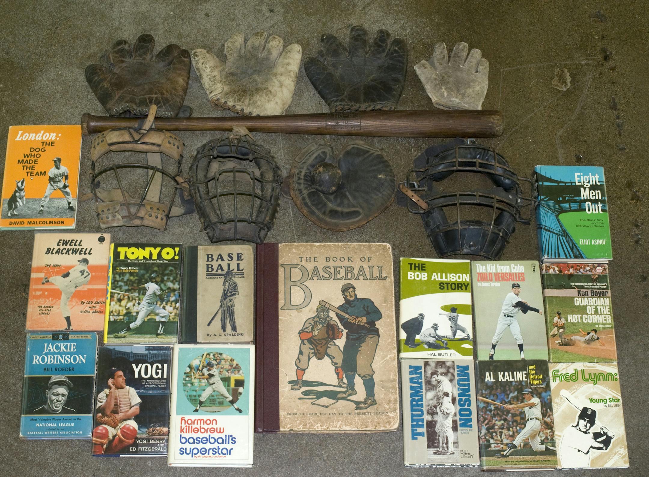 The photo is by Carrie Elizabeth Thompson of Soth Photography Inc. The picture is of some of the books and other baseball paraphernalia that will be sold, including 19th century mitts and early versions of catcher‚Äôs masks.