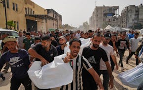 Palestinians carry the bodies of their relatives killed in an Israeli army airstrike, during their funeral in Khan Younis, Gaza Strip, Sunday, May 18,