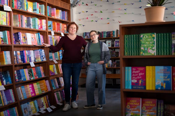 Lauren Richards, left, and Caitlin O'Neil, co-owners of romance bookstore Tropes & Trifles, pose for portrait inside their bookstore in Minneapolis, M
