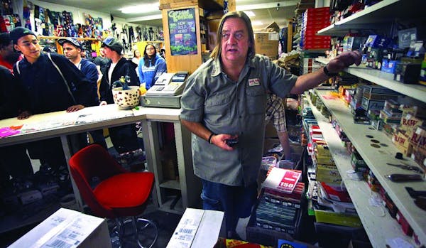 Jim Carlson worked with customers at his store, The Last Place on Earth, in downtown Duluth.