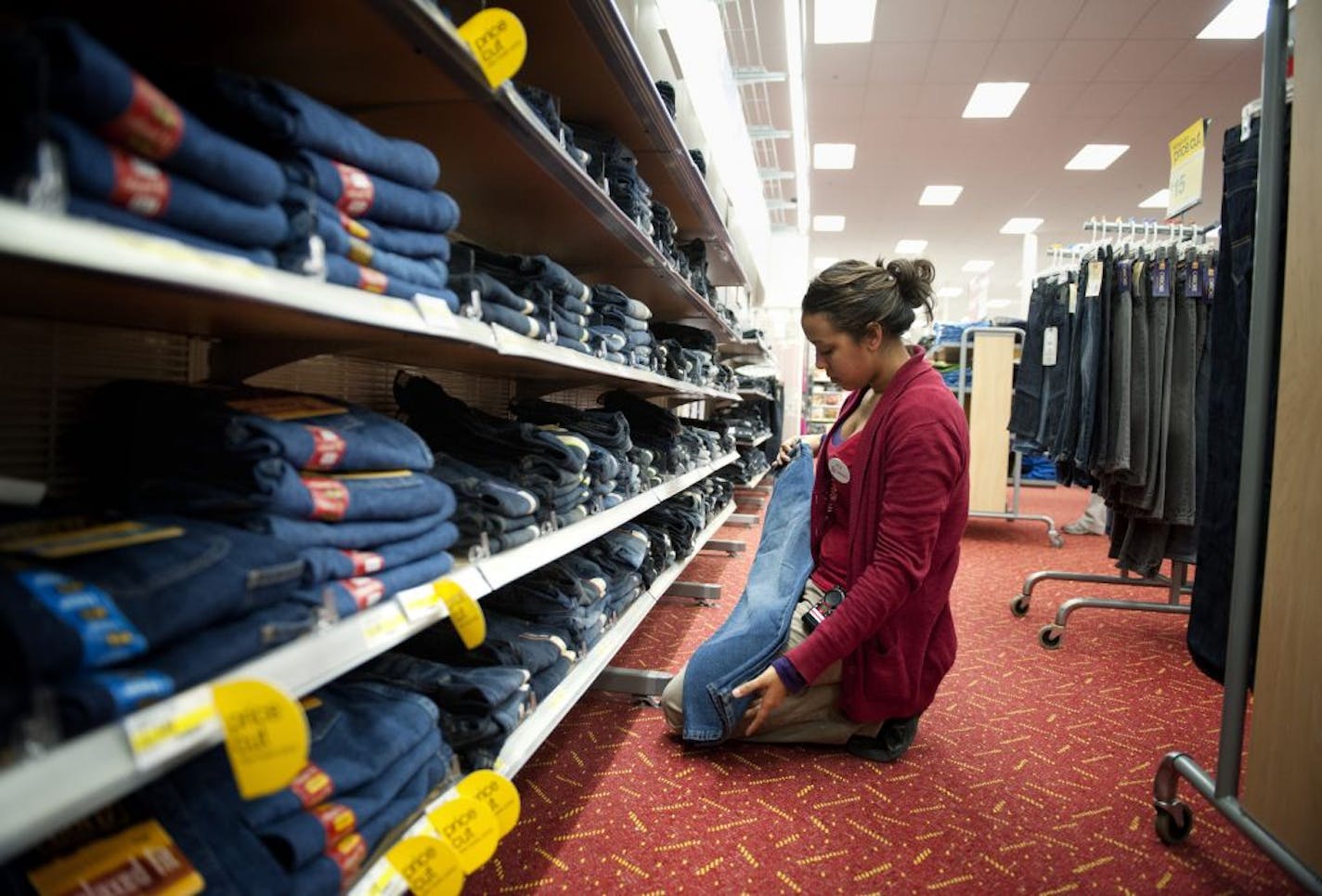 Target employee Alicia O'Neal folded boys' jeans Thursday at the Edina store. Clothing did well for Target last month.