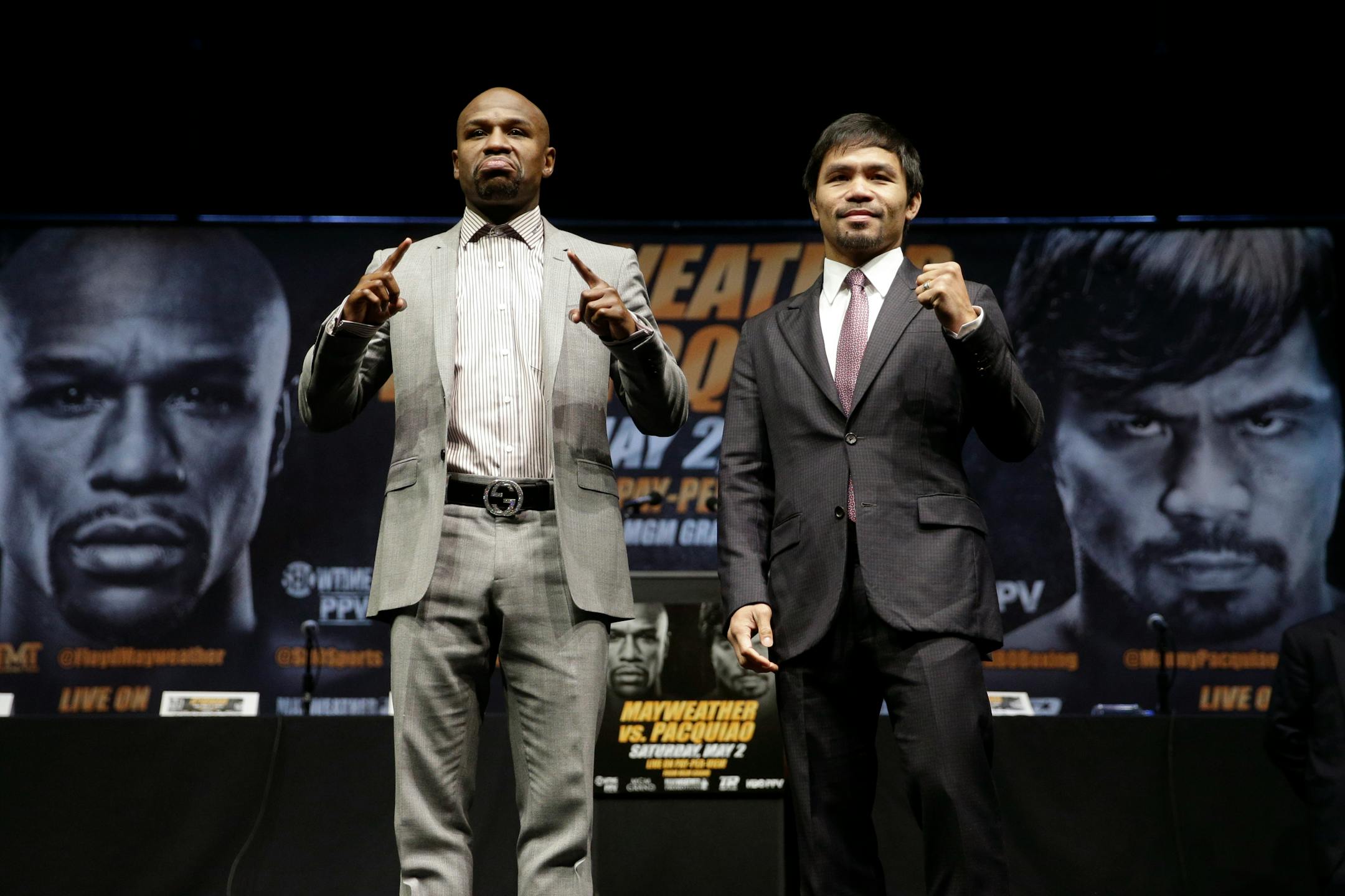 Boxers Floyd Mayweather Jr., left, and Manny Pacquiao, of the Philippines, pose for photos after a news conference, Wednesday, March 11, 2015, in Los Angeles. The two are scheduled to fight in Las Vegas on May 2. (AP Photo/Jae C. Hong)