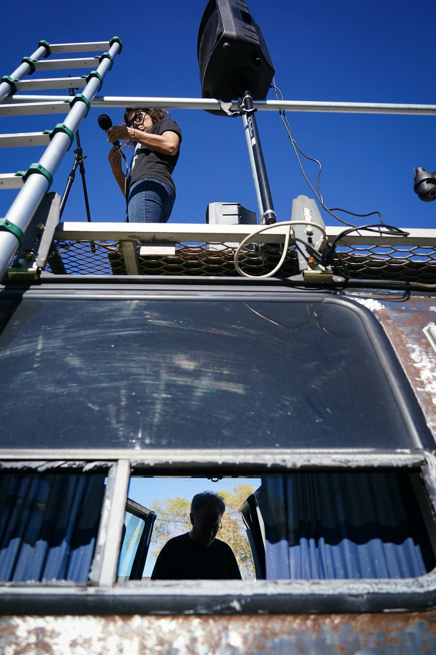 Carly Beseman held a mic on the roof stage as Stewart DeVann was on the ground during a mic check.