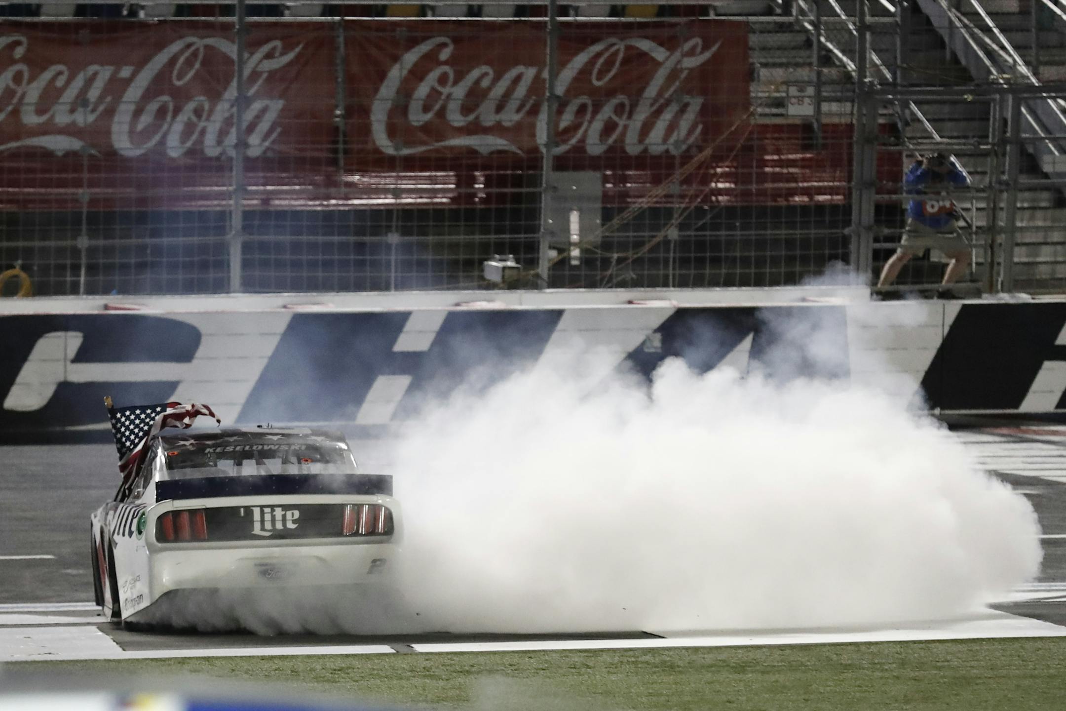 Brad Keselowski does a burnout after winning the NASCAR Cup Series auto race at Charlotte Motor Speedway early Monday, May 25, 2020, in Concord, N.C. (AP Photo/Gerry Broome)